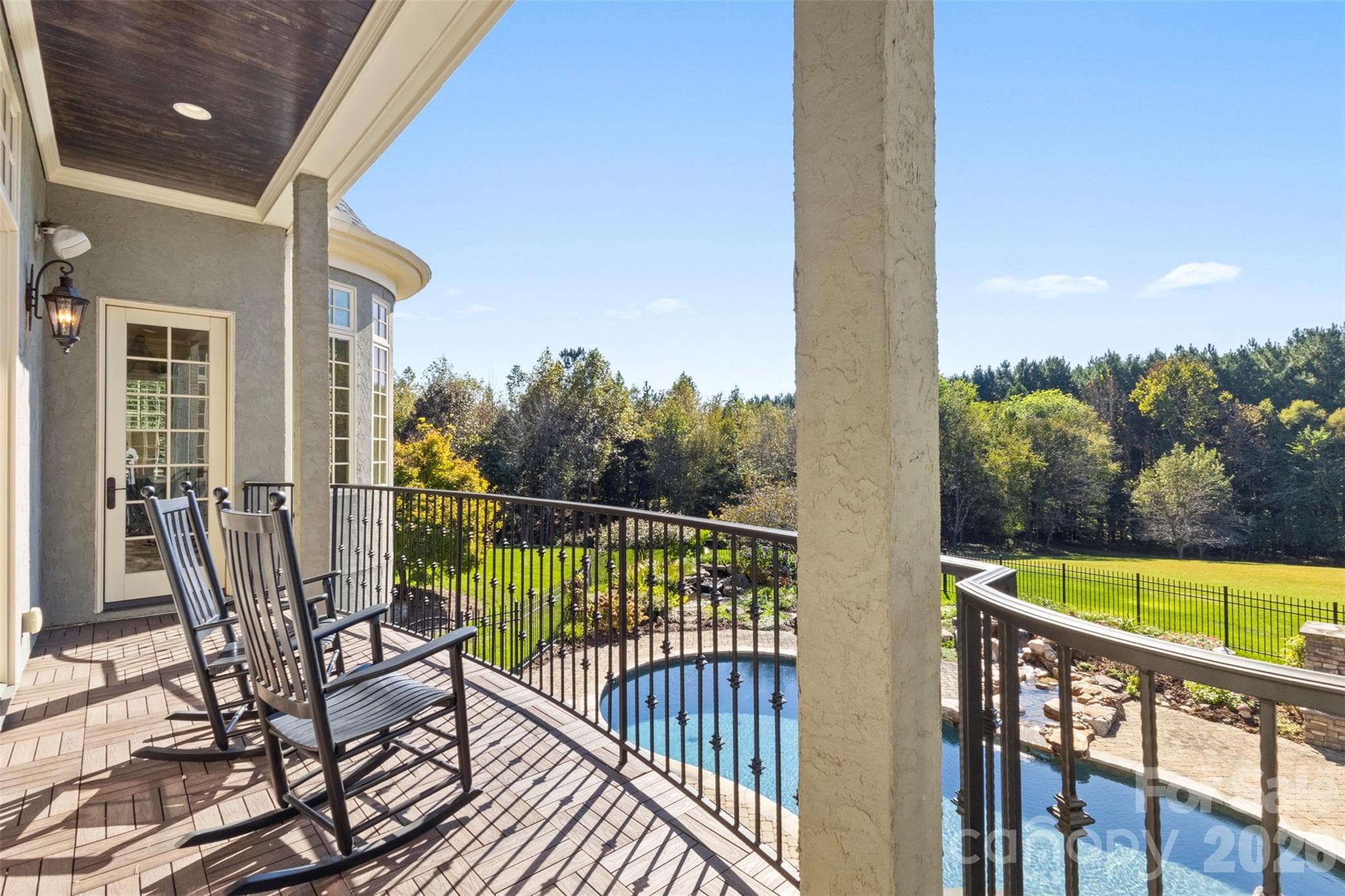 Balcony overlooking the pool below, accessible from multiple areas of the home - 973 Pinnacle Drive, Iron Station