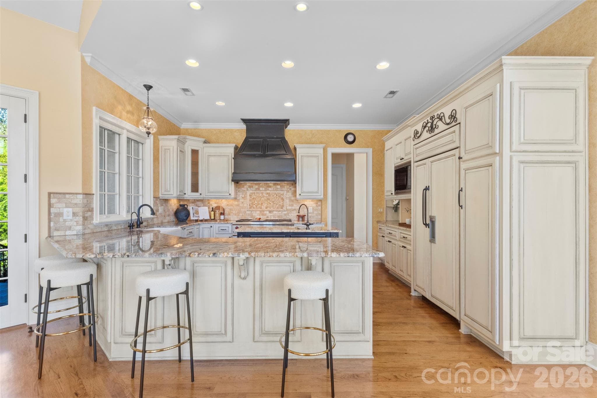 Kitchen peninsula offers bar style seating area with a dedicated prep island with sink in the center of the kitchen - 973 Pinnacle Drive, Iron Station