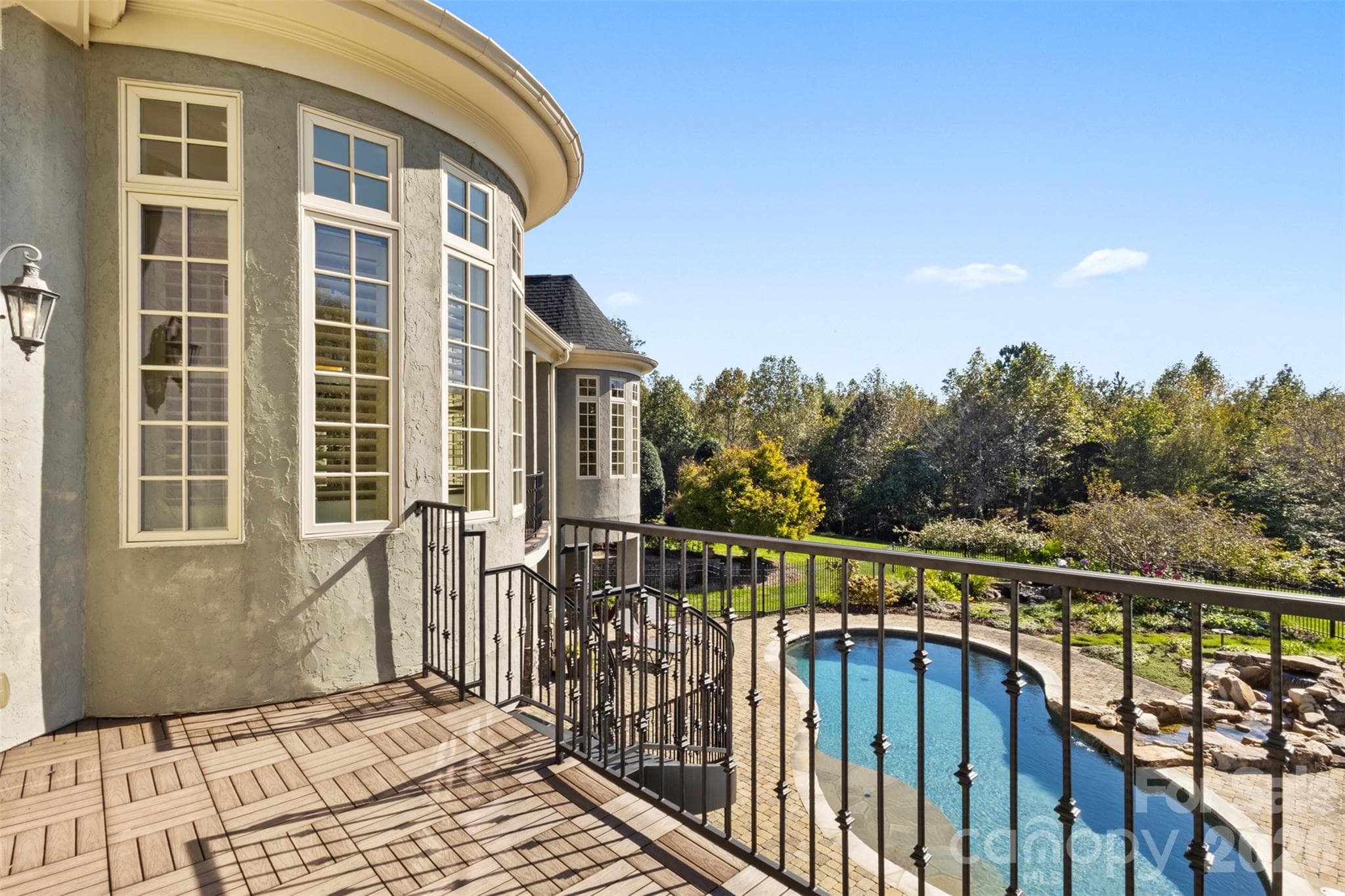 Balcony area off the hearth room with stairs leading to the rose garden - 973 Pinnacle Drive, Iron Station