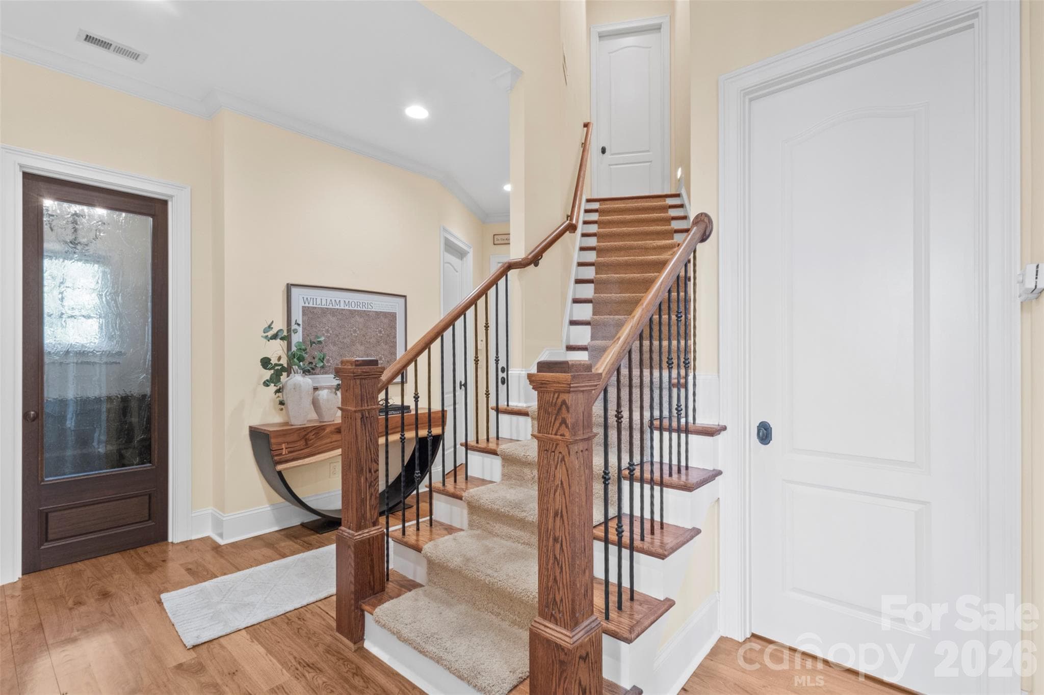 Bonus room staircase tucked near the scullery and garage entrance - 973 Pinnacle Drive, Iron Station