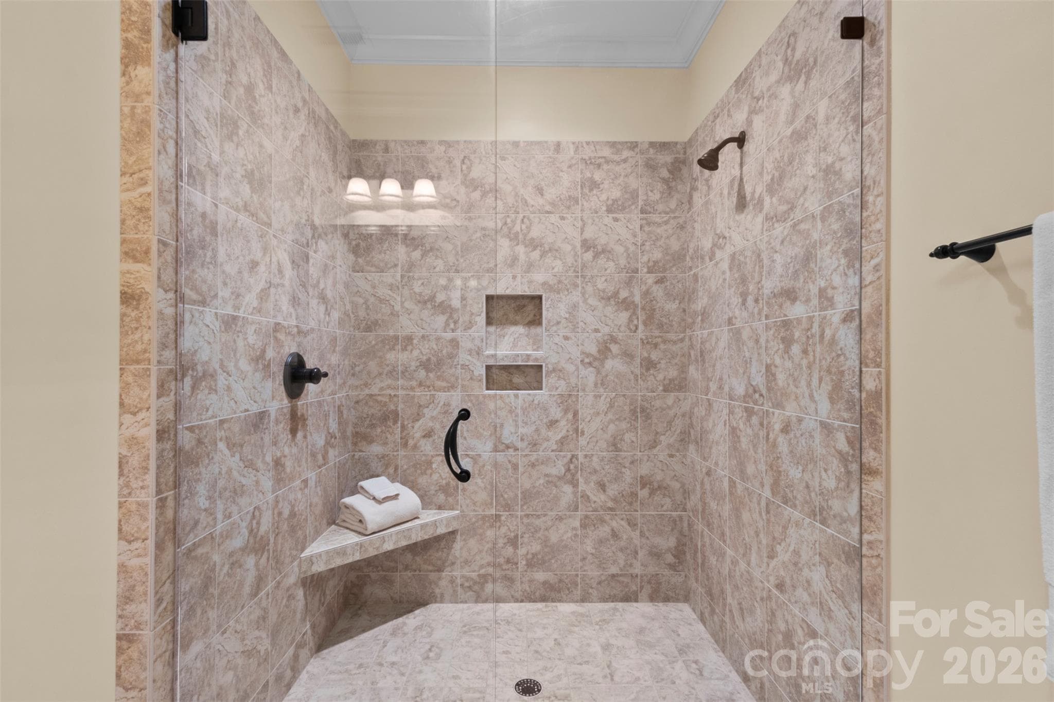 Tiled shower in the en-suite bath for the yellow bedroom on the lower level - 973 Pinnacle Drive, Iron Station