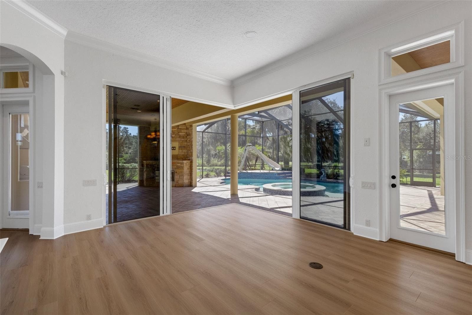 The dual stacking sliders open completely at the corner to bring the outdoors inside at any time of the year. - 6562 EAGLE VIEW LOOP, LAKELAND