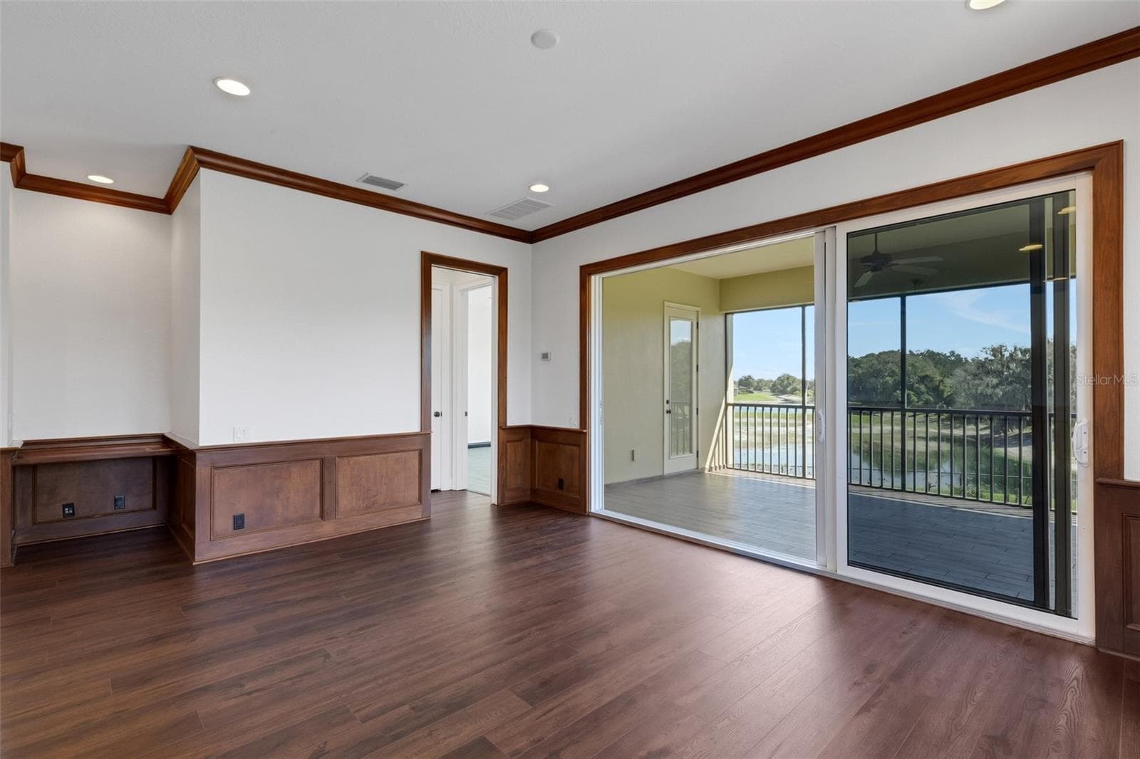 With a built-in desk, wood wainscoting accents, large stacking slider that opens to the screen enclosed balcony overlooking the pool area below. - 6562 EAGLE VIEW LOOP, LAKELAND