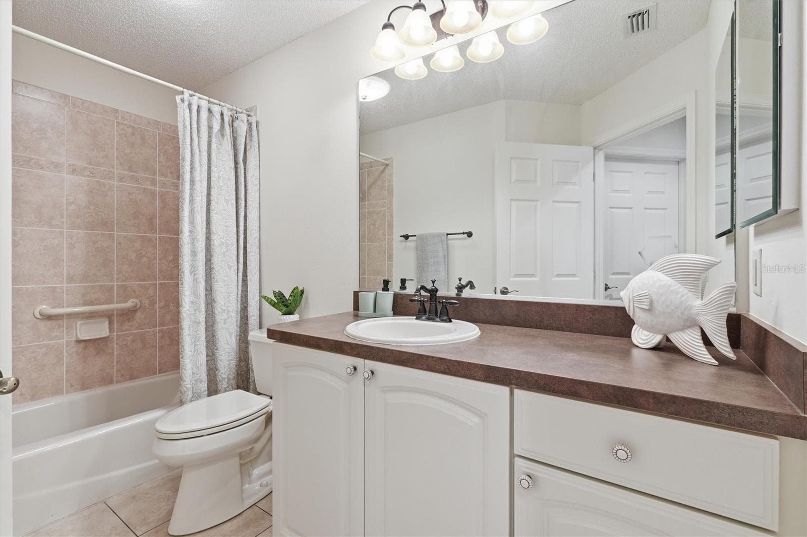 Guest Bathroom, high countertops, Tile Shower/Tub combo. Linen closet in hallway. - 1563 EASTOVER TER, THE VILLAGES