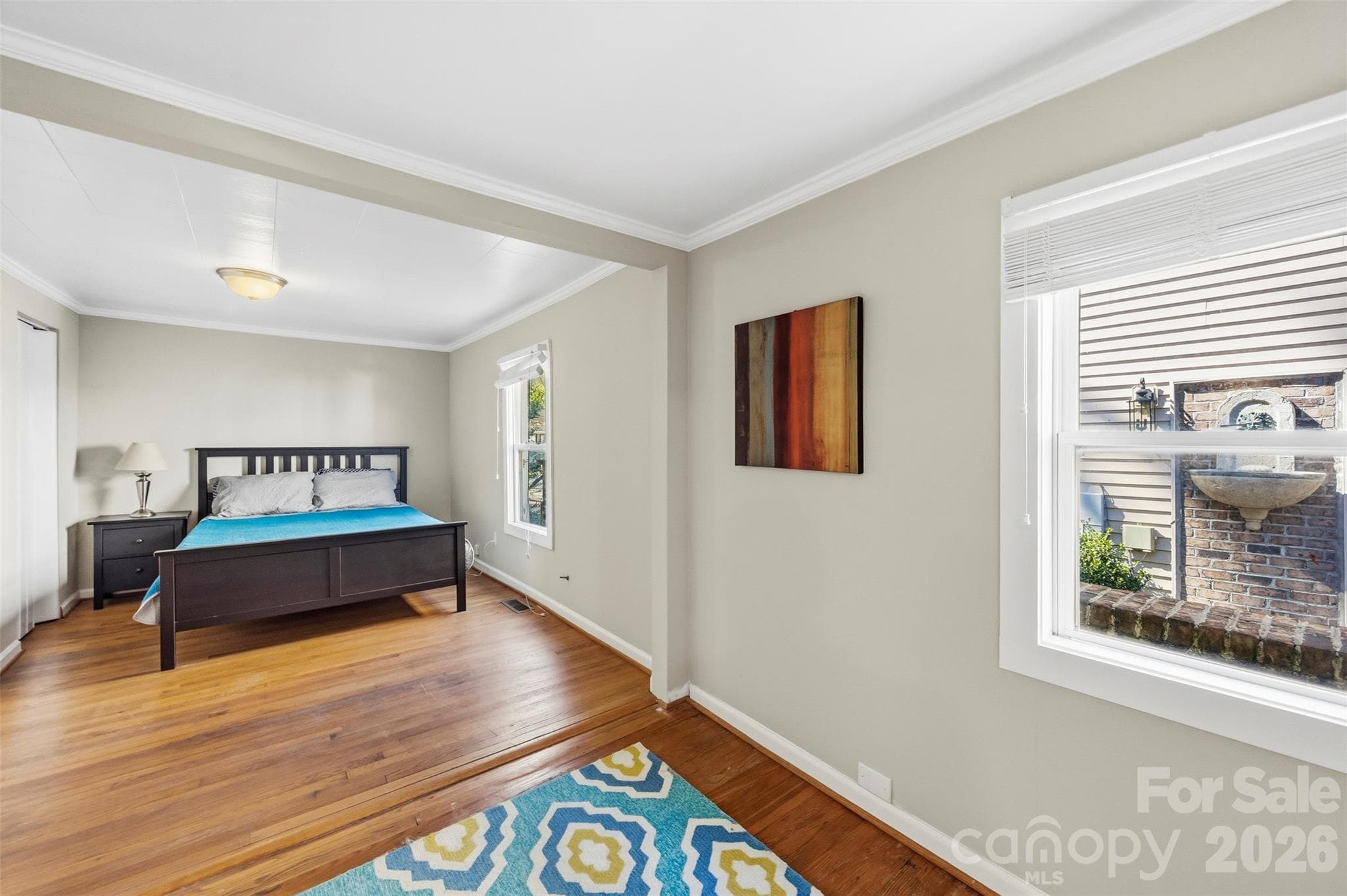 Primary bedroom (11'6" x 23'4") with hardwood floors. - 220 Armour Street, Davidson