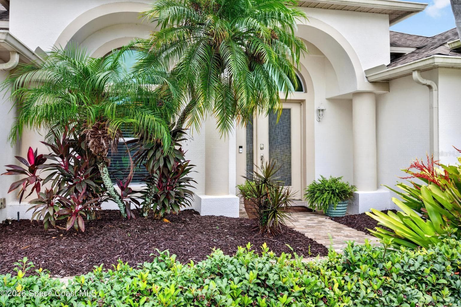 Arched entry, tropical landscaping - 3726 SUNWARD DR, MERRITT ISLAND