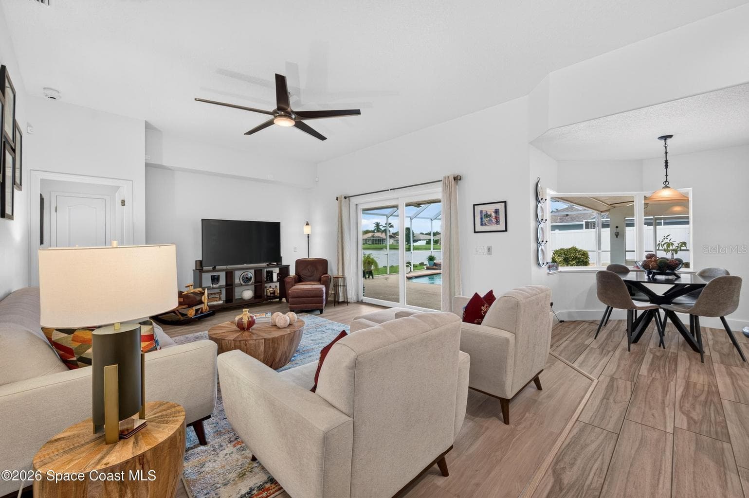 Family room and nook with lake views - 3726 SUNWARD DR, MERRITT ISLAND