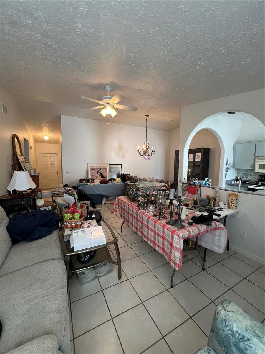 View of living room, dining room and entry. - 4715 STONEPOINTE PL, TAMPA