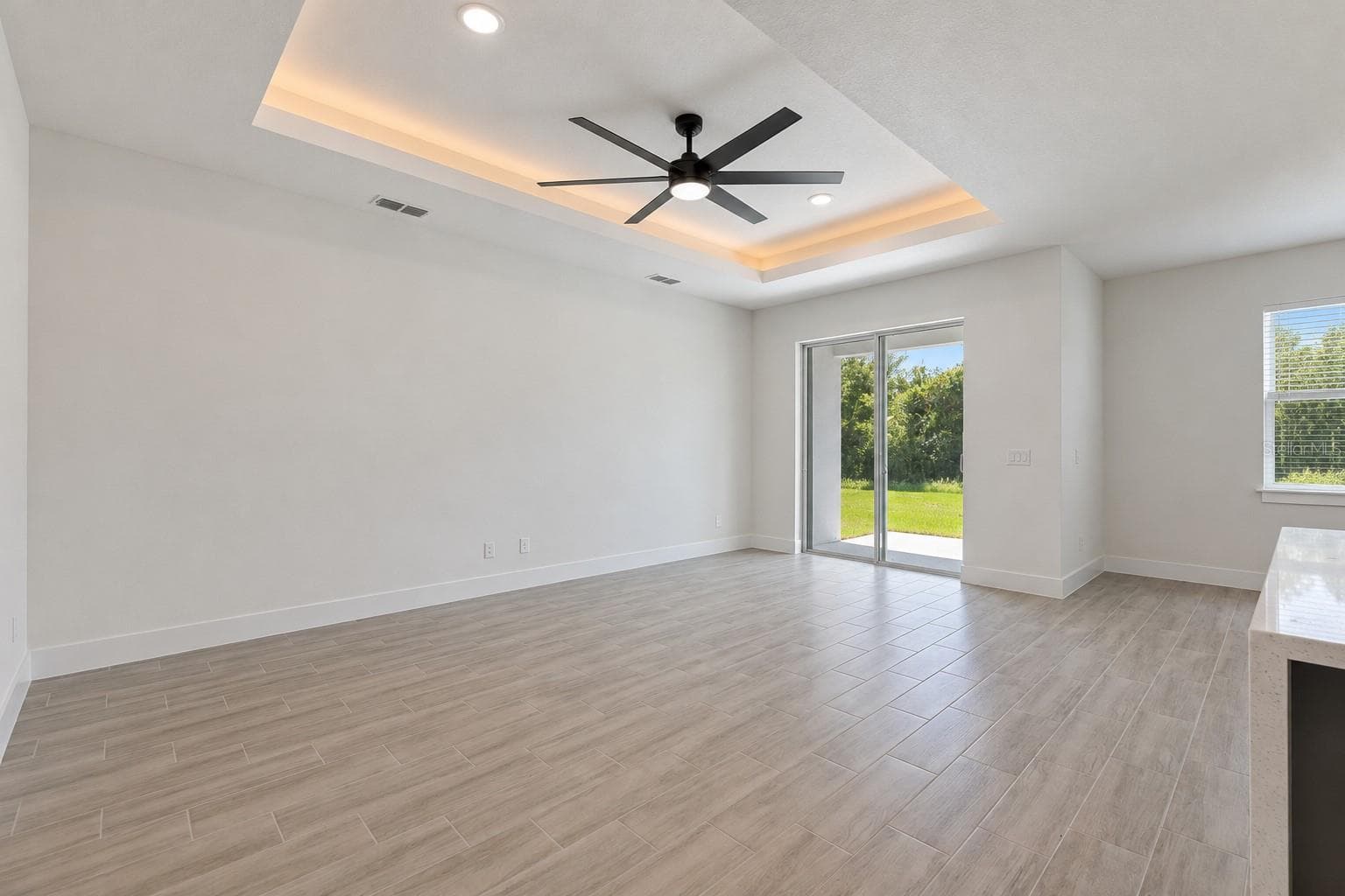 Living room. Digitally edited model/property composite. - 24479 SW KINGSWAY CIR, ARCADIA
