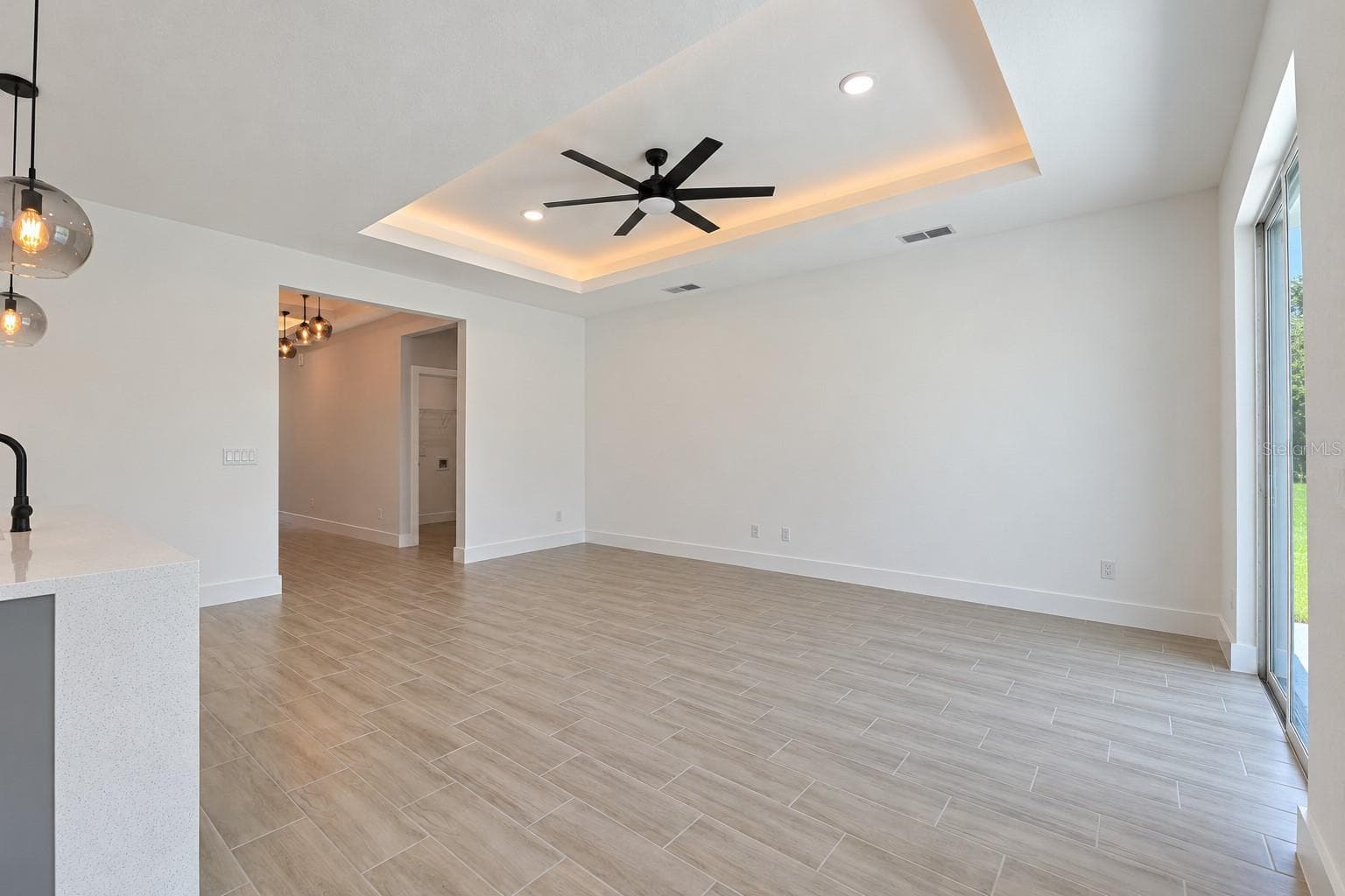 Living room reverse view. Digitally edited model/property composite. - 24479 SW KINGSWAY CIR, ARCADIA
