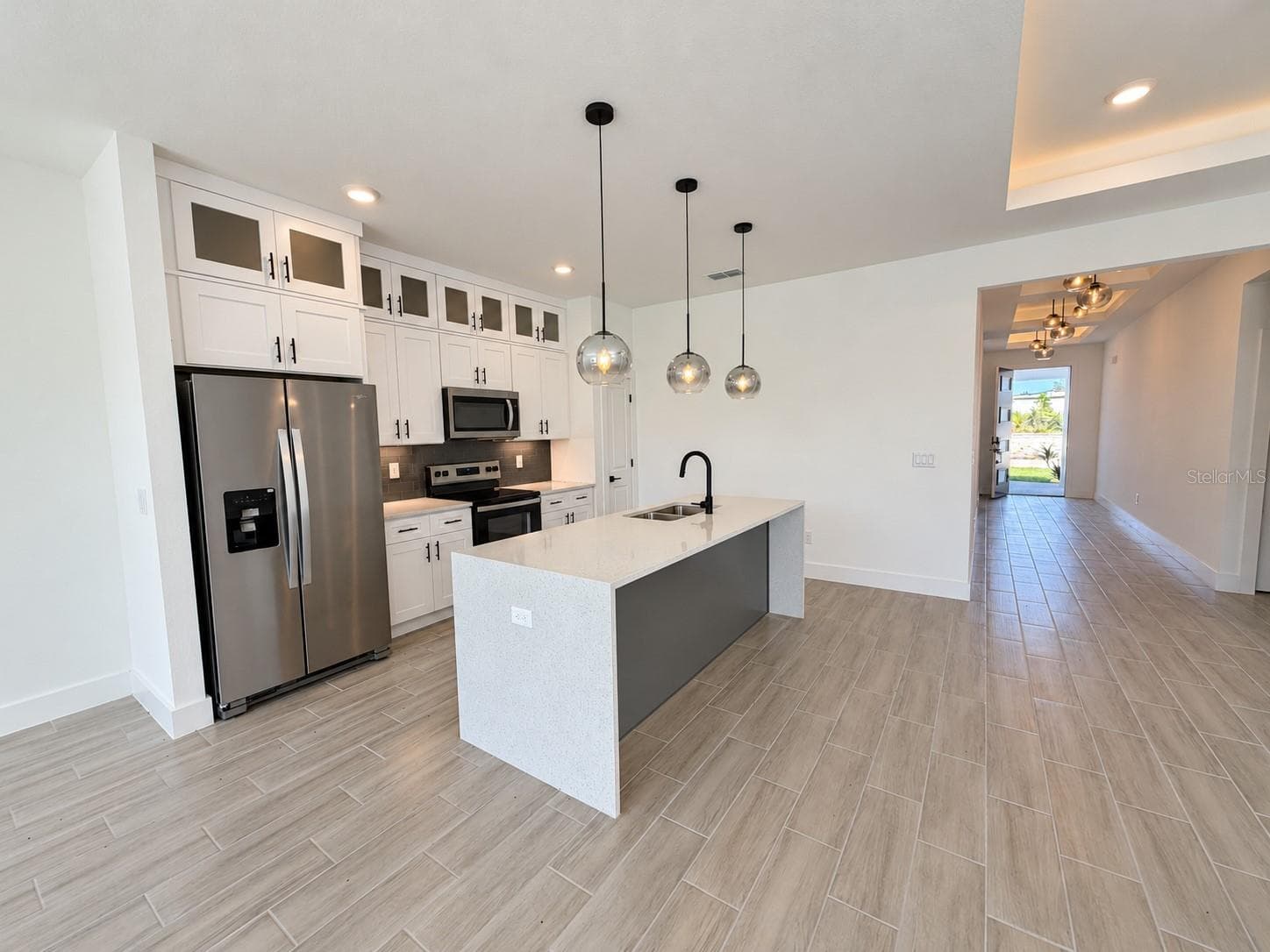 Kitchen toward entry. Actual property photo, digitally refined. - 24479 SW KINGSWAY CIR, ARCADIA