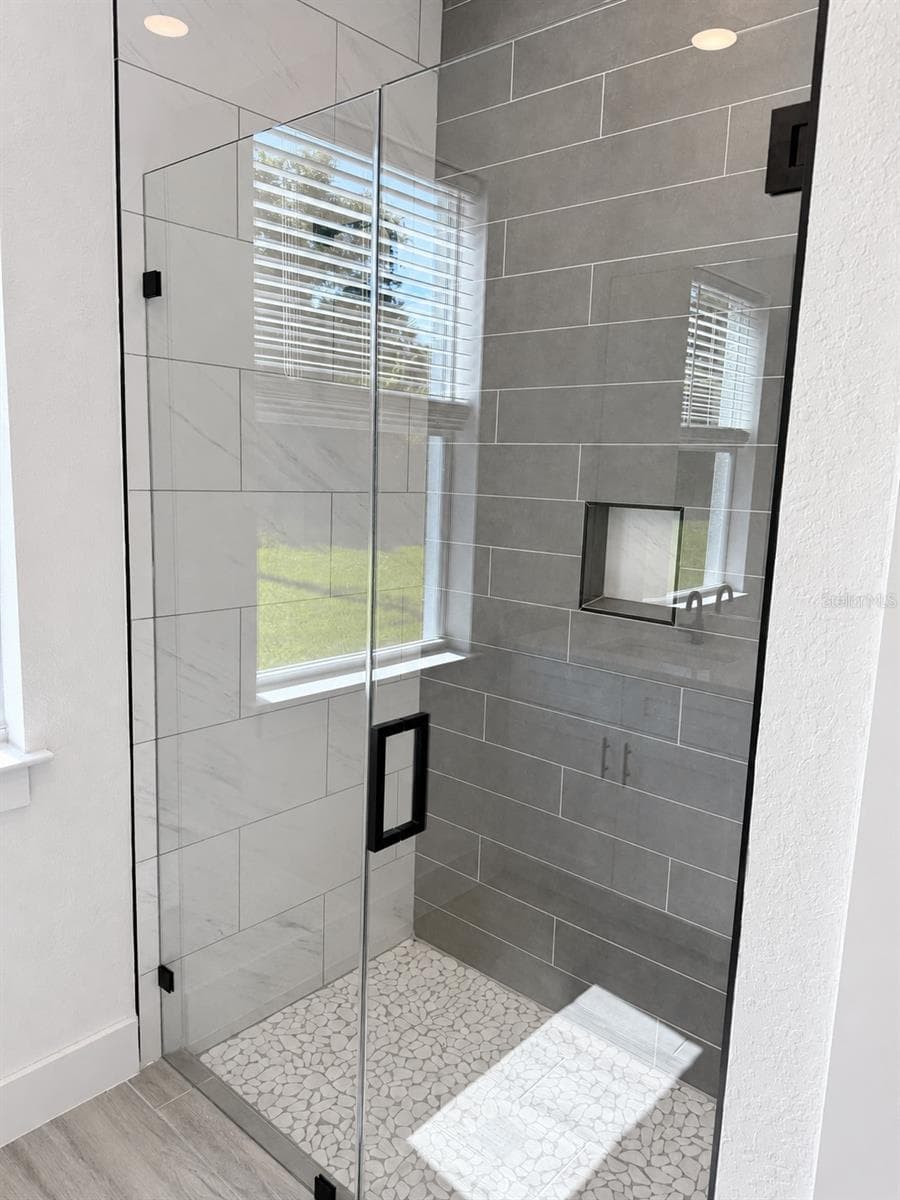Primary glass shower. Actual property photo, digitally refined. - 24479 SW KINGSWAY CIR, ARCADIA