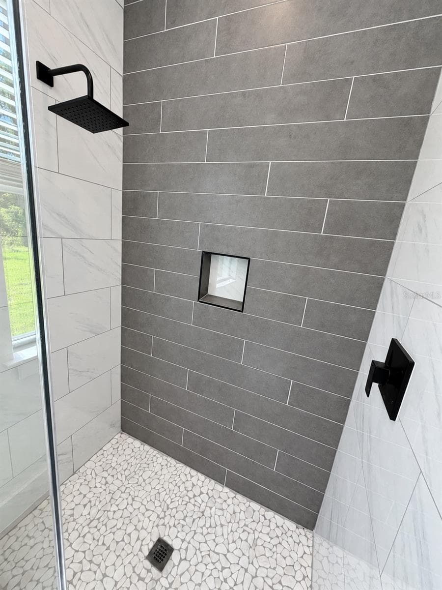 Primary shower tile detail. Actual property photo, digitally refined. - 24479 SW KINGSWAY CIR, ARCADIA