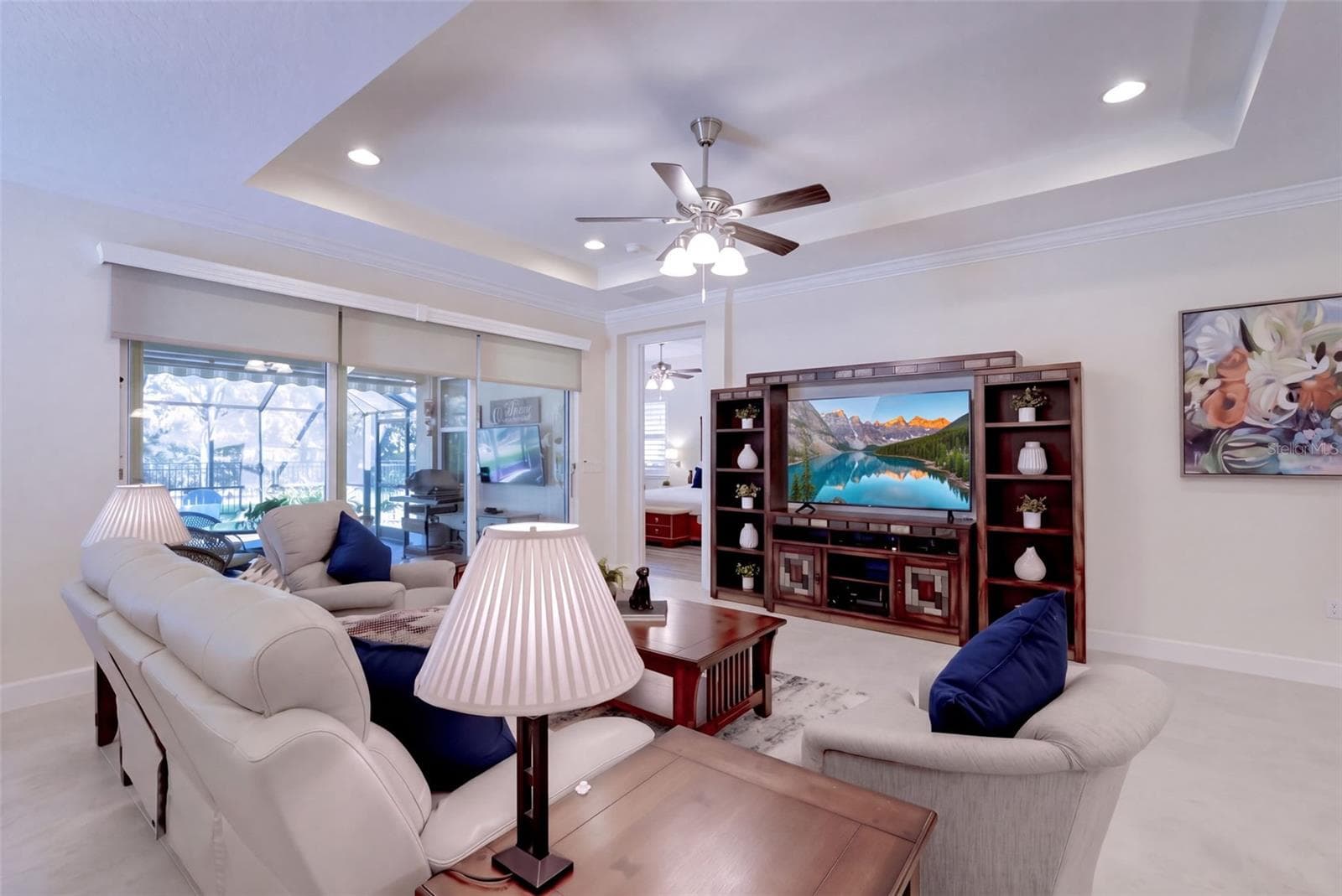 15'6" x 18' Great Room w/ tray ceiling, recessed lighting, crown molding & remote controlled shades for the sliding glass doors - 1233 EGGLESTON DRIVE, DELAND