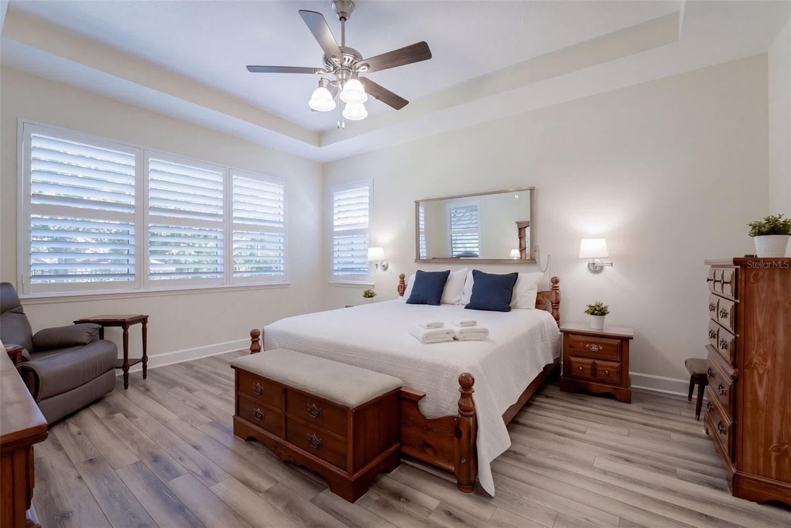 14' x 17' Primary Bedroom w/ a luxury vinyl floor, tray ceiling & a ceiling fan - 1233 EGGLESTON DRIVE, DELAND
