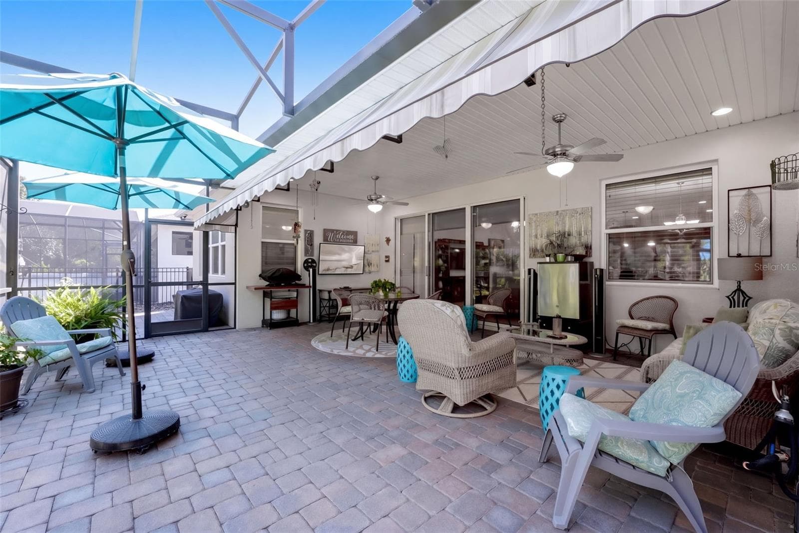 Screen enclosed covered Lanai w/ brick pavers & a wall mounted flat screen TV - 1233 EGGLESTON DRIVE, DELAND