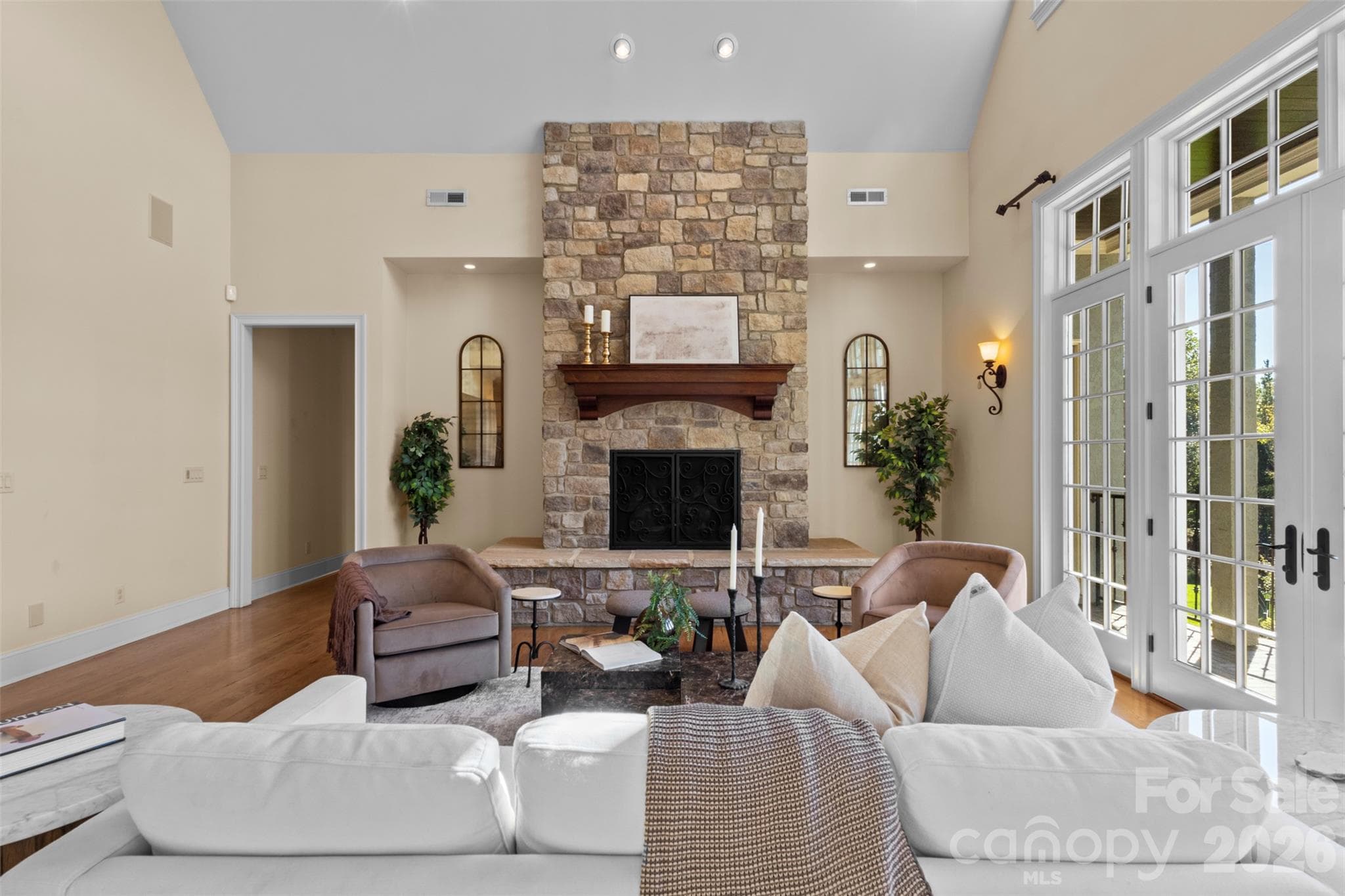 Stone fireplace creates a moment to appreciate with raised hearth and is one of 4 propane fireplaces within the home - 973 Pinnacle Drive, Iron Station