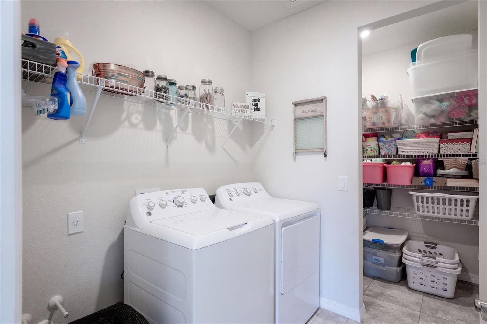 Laundry room with extra storage closet and plumbing hookups for uitlity sink - 4773 RIVERWALK DR, ST CLOUD