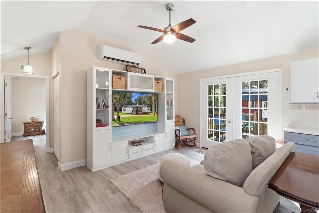Open Living Area – Another beautiful view of the comfortable living room, showcasing the open layout, attractive furnishings, w/ entertainment center & French doors leading outdoors. - 6230 W GLEN ROBBIN CT, CRYSTAL RIVER