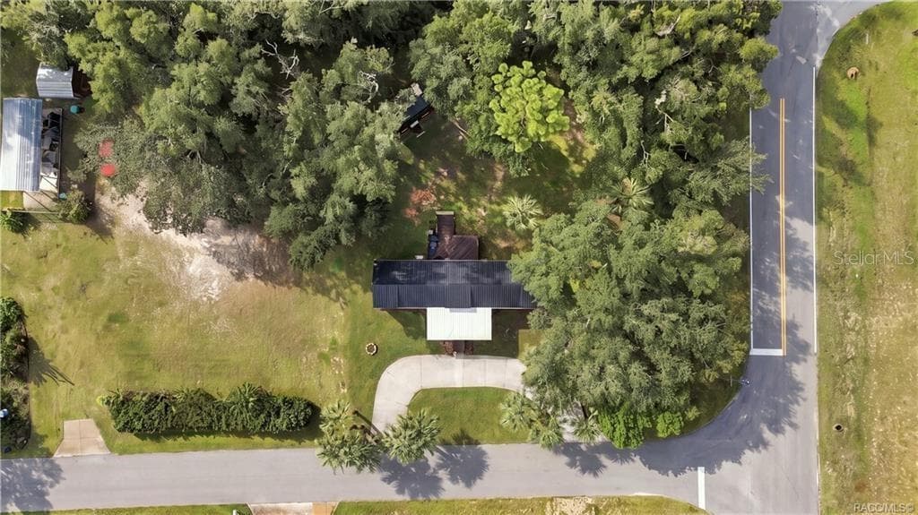Aerial Property View – Beautiful overhead perspective showcasing the .29-ACRE CORNER HOMESITE, METAL ROOF, circular concrete driveway, mature shade trees & spacious lawn. - 6230 W GLEN ROBBIN CT, CRYSTAL RIVER