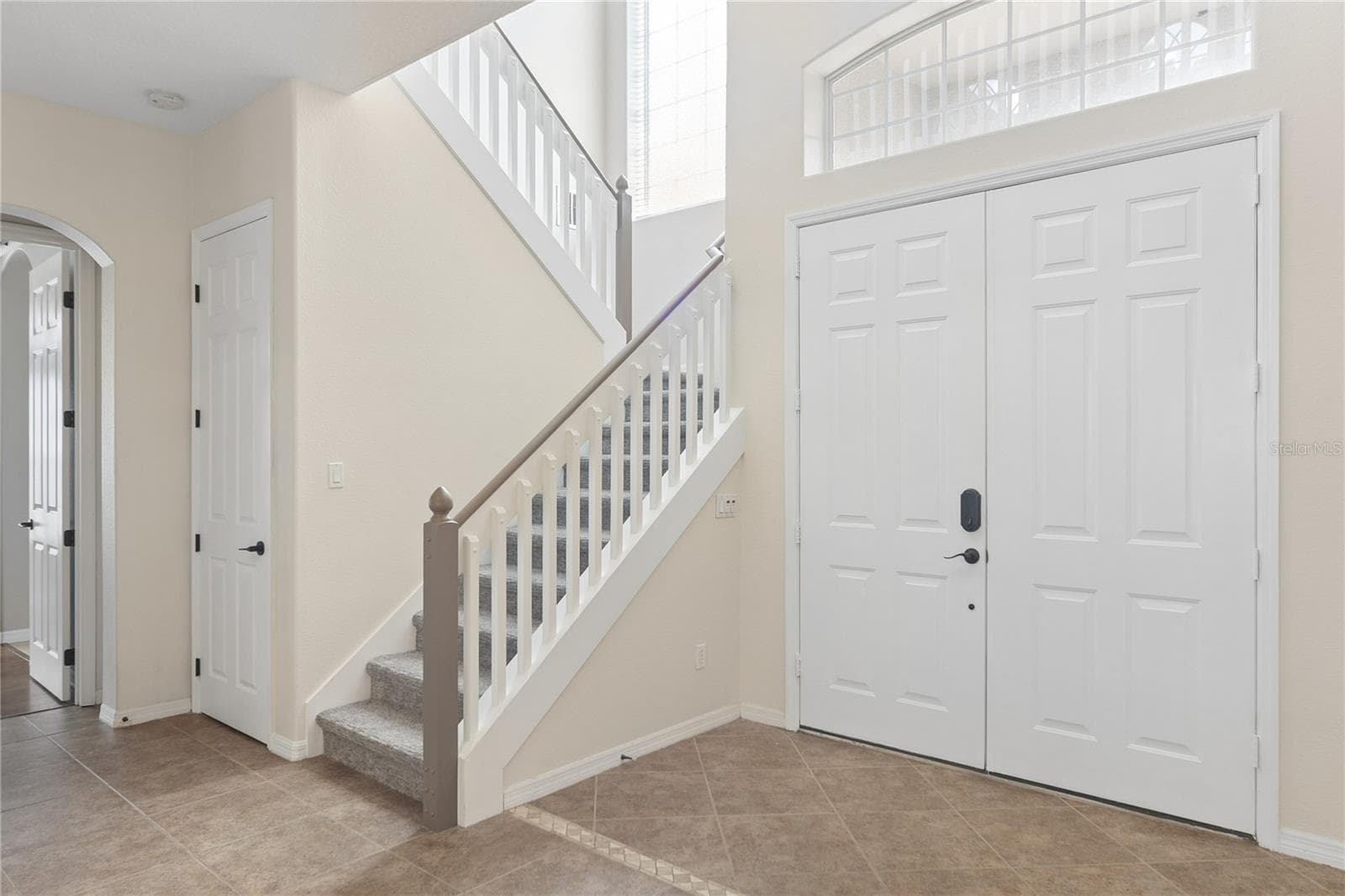 Going thru the double doors into a 2 story foyer and the grand staircase. - 16169 BRISTOL LAKE CIR, ORLANDO