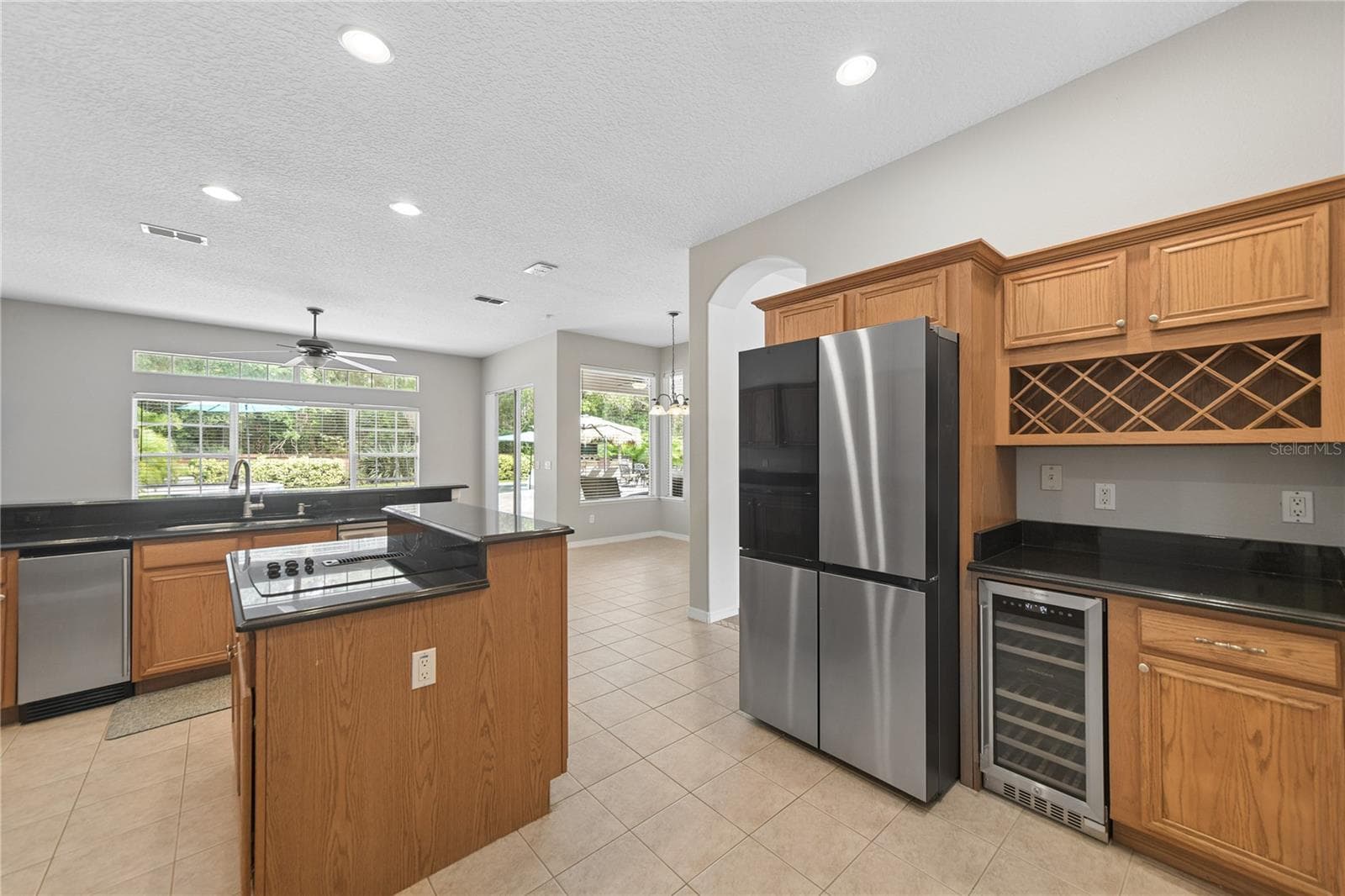 Here you can see the new ice maker next to the sink, along with the new Samsung 4 door refrigerator and wine fridge. - 16169 BRISTOL LAKE CIR, ORLANDO