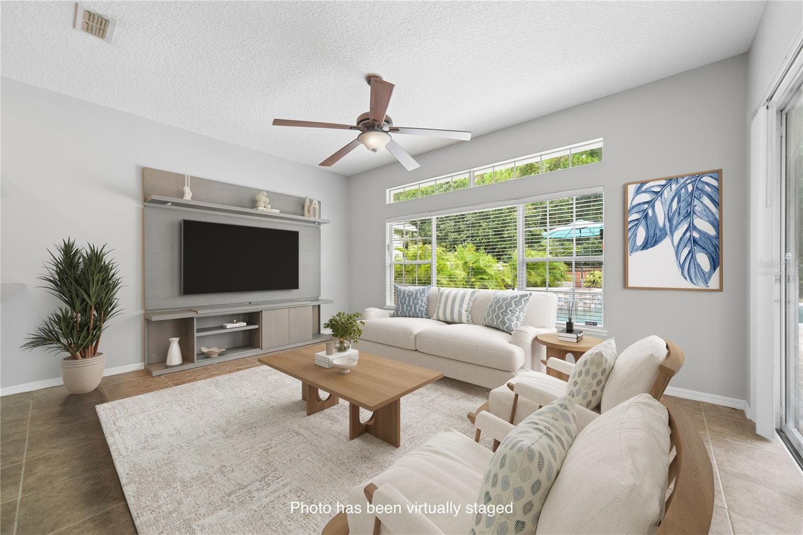 On the other side of the breakfast bar is this spacious family room that over looks the pool in the back yard (photo virtually staged). - 16169 BRISTOL LAKE CIR, ORLANDO