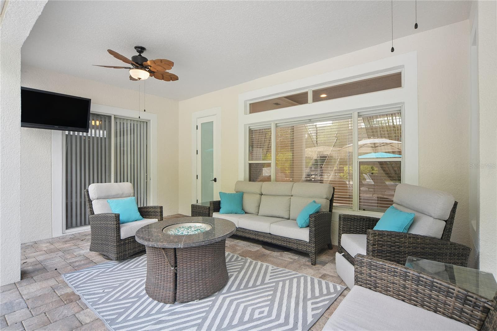 Right outside the family room sliding door is this spacious lanai where you can spend rainy days under cover, take a break from the bright sunshine, or enjoy winter nights by the fire. There are 2 new ceiling fans here, the TV stays and the furniture is negotiable. - 16169 BRISTOL LAKE CIR, ORLANDO