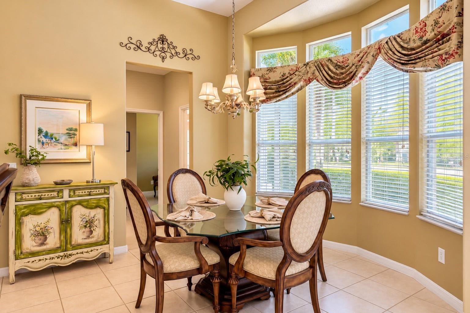 CHARMING BREAKFAST NOOK FEATURING SOARING CEILINGS, ELEGANT LIGHTING, AND A BEAUTIFUL CURVED WALL OF WINDOWS THAT FILLS THE SPACE WITH NATURAL LIGHT! Enjoy peaceful mornings with your favorite cup of coffee while overlooking the lush outdoor landscaping. The perfect setting for casual dining and everyday gatherings! - 14542 RIVIERA POINTE DR, ORLANDO