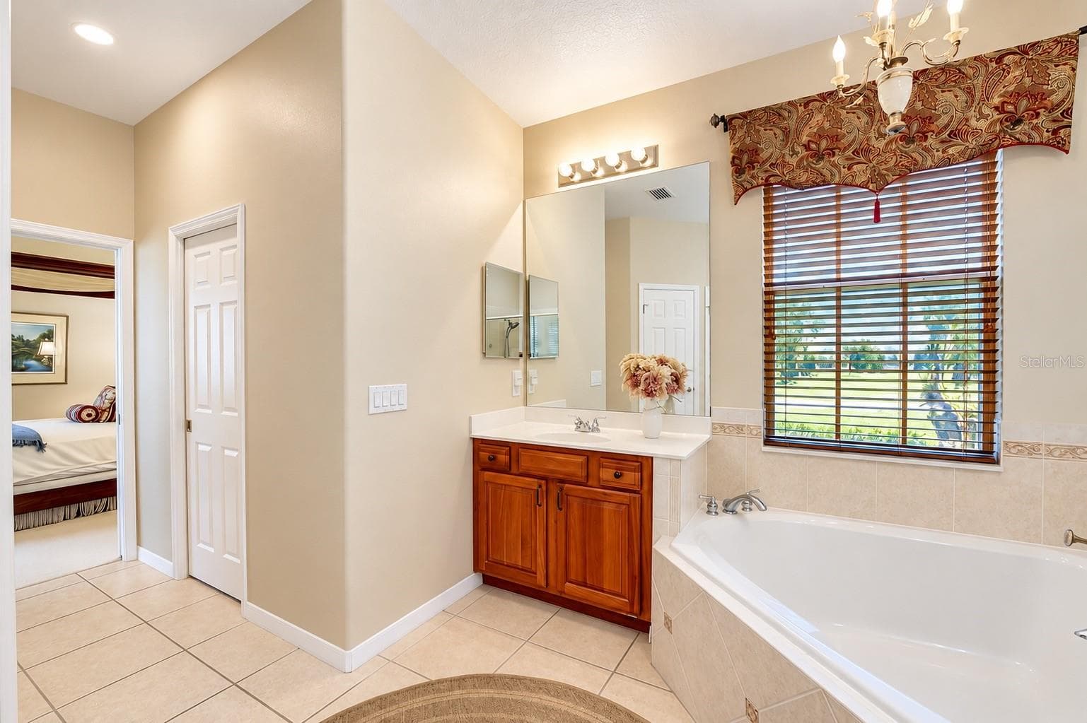 DUAL VANITIES WITH RICH WOOD CABINETRY, A LARGE SOAKING GARDEN TUB, AND A SEPARATE WALK-IN SHOWER WITH CUSTOM TILEWORK AND GLASS ENCLOSURE! - 14542 RIVIERA POINTE DR, ORLANDO