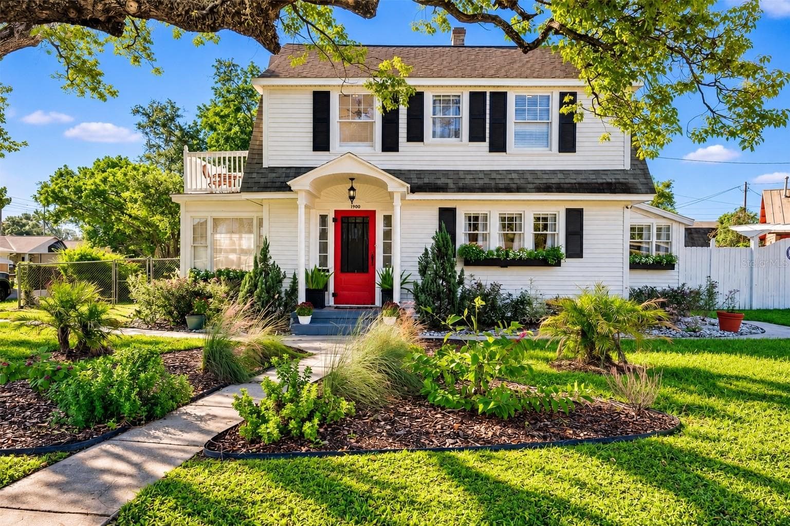 CHARMING TWO-STORY HOME SITUATED ON AN EXPANSIVE .34-ACRE LOT WITH NO HOA! Beautiful white siding, contrasting black shutters, and a welcoming red front door create picture-perfect curb appeal. A covered front entry, charming window flower boxes, and mature landscaping add warmth and character, while a majestic oak tree provides beautiful natural shade. The spacious .34-ACRE PROPERTY is a gardener's paradise, featuring a wonderful variety of EDIBLE FRUIT TREES, PLANTS, AND HERBS, creating your very own backyard oasis! Enjoy the beauty of nature, the joy of homegrown harvests, and the freedom of NO HOA! - 1901 10TH ST, ST CLOUD