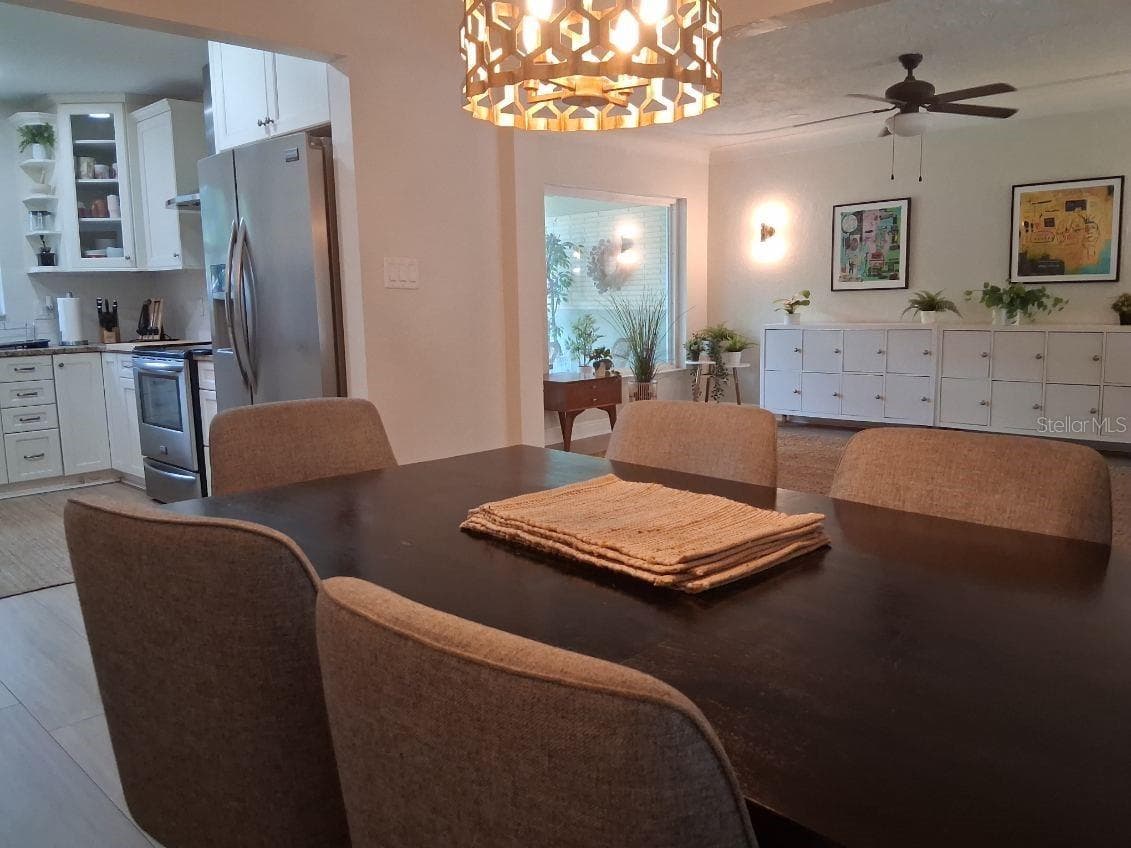 Dining room is open to the kitchen, and the great room, yet has its own designated space - 8220 YARDLEY AVE N, ST PETERSBURG