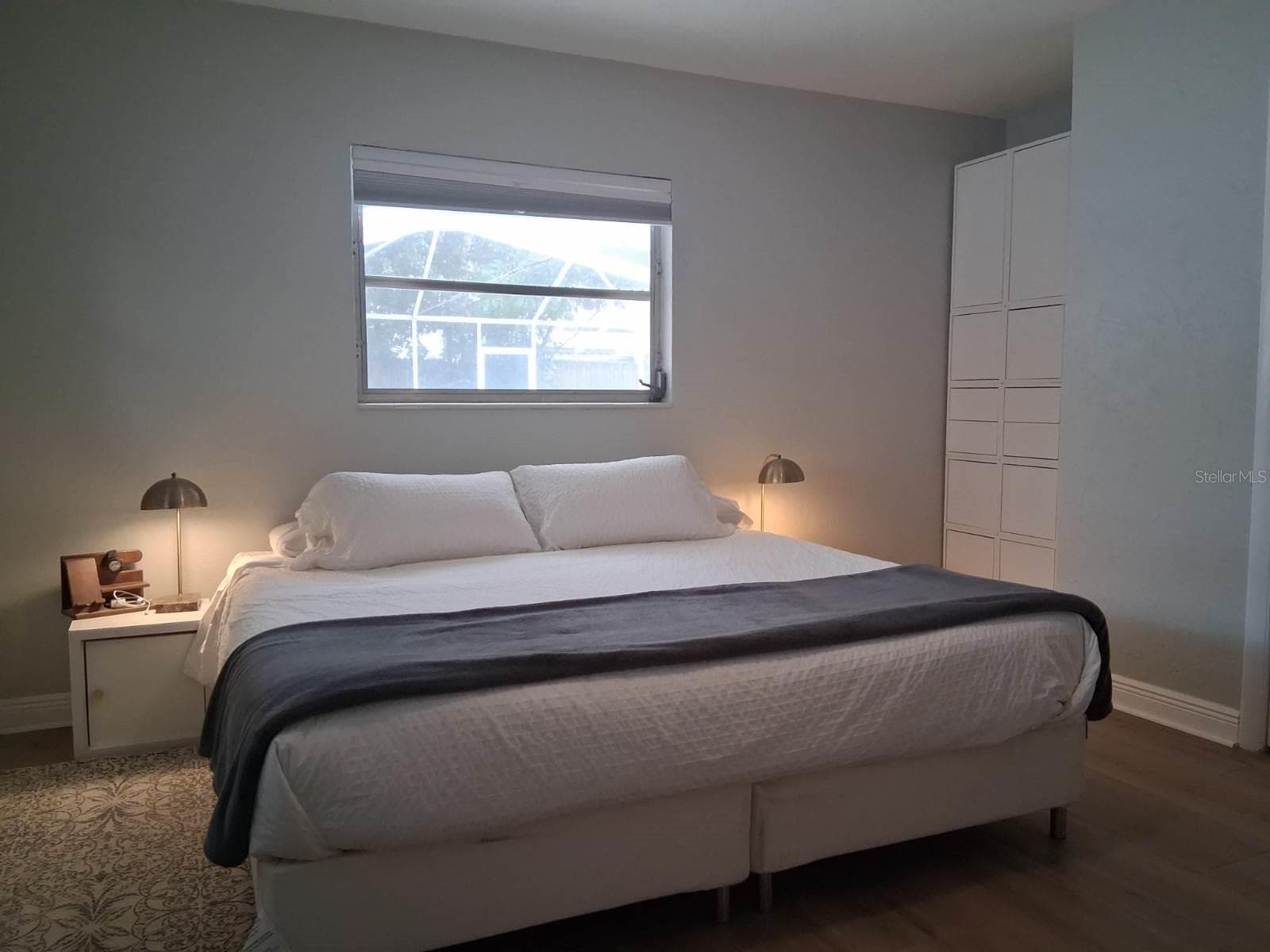 Primary Bedroom with a view out to the pool - 8220 YARDLEY AVE N, ST PETERSBURG