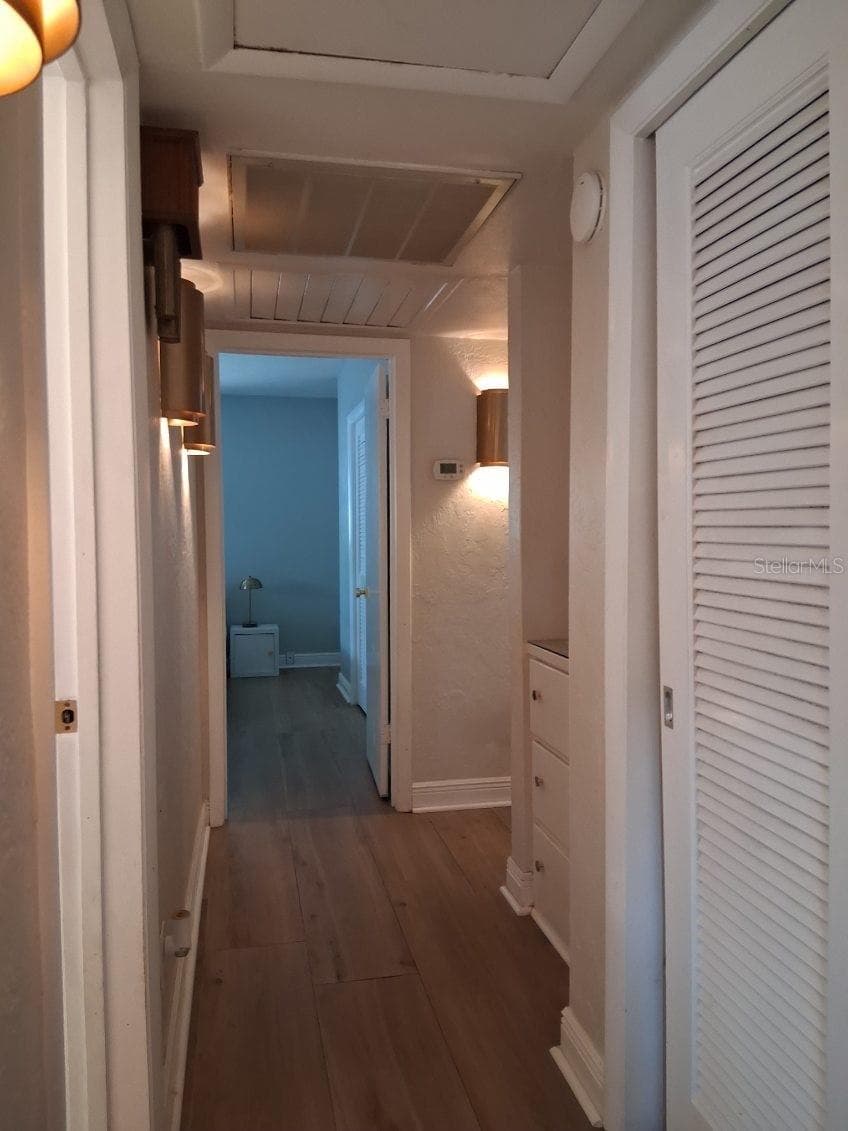 Downstairs hall with custom lighting and built-in cupboards for extra storage - 8220 YARDLEY AVE N, ST PETERSBURG