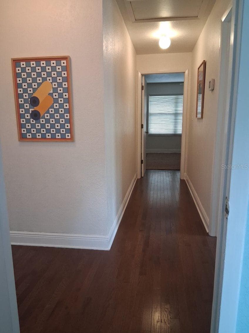 Upstairs Hallway with gleaming hardwood floors - 8220 YARDLEY AVE N, ST PETERSBURG