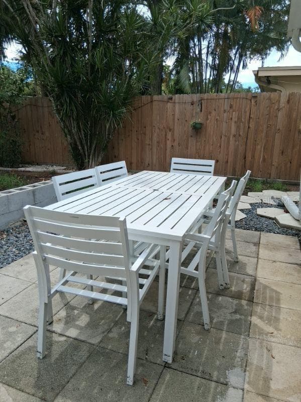 Room for dining outside, or working, or enjoying the abundant greenery, salt breeze off the water, and chirping parrots that also live in Jungle Prada - 8220 YARDLEY AVE N, ST PETERSBURG