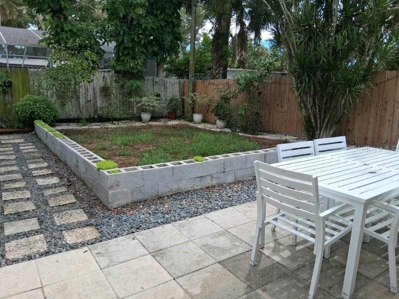 Newer drainage and landscaping in backyard; the key lime trees are next to the back fence - 8220 YARDLEY AVE N, ST PETERSBURG