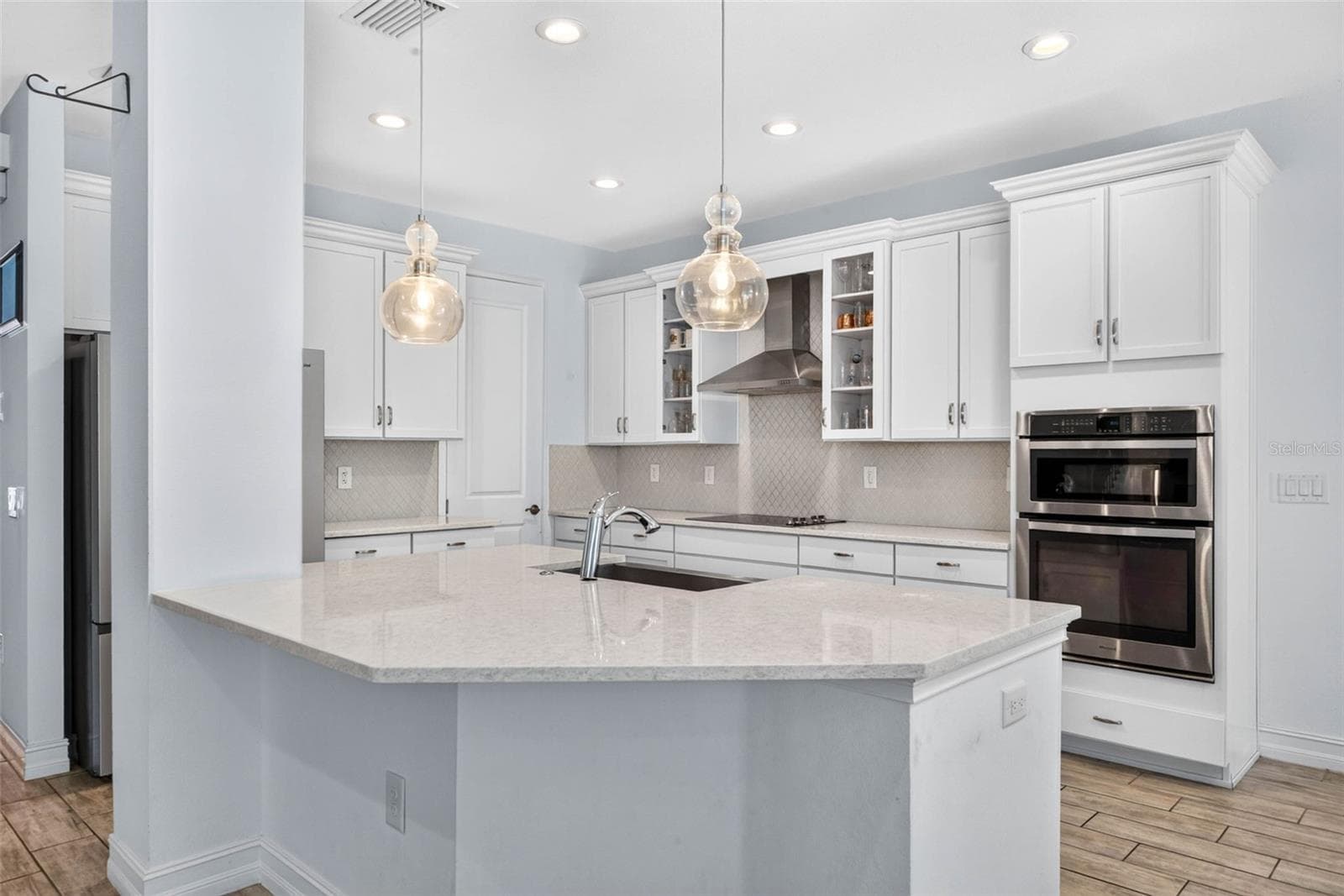 Updated kitchen with double wall oven, closet pantry, cooktop, and island. - 33455 AZALEA RIDGE DR, WESLEY CHAPEL