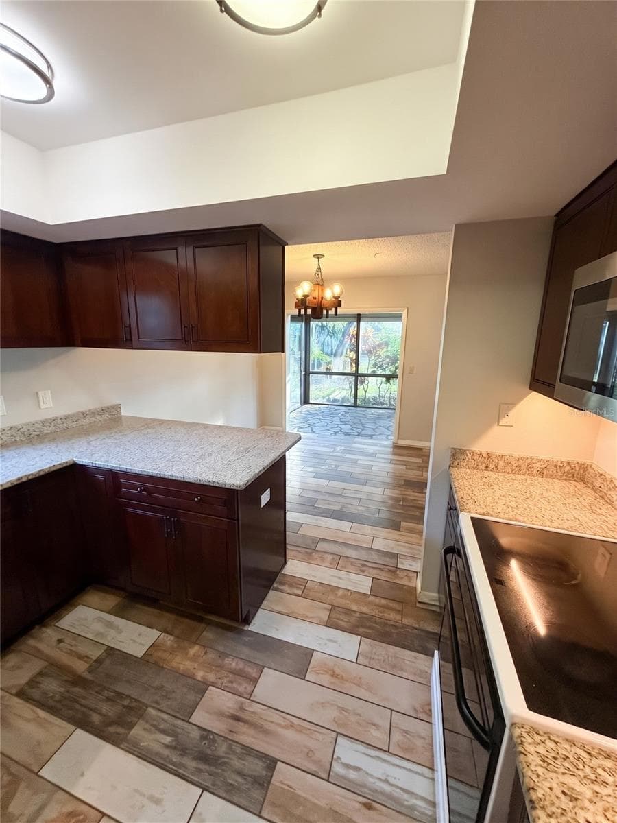 Kitchen View To Dining & Sunroom - 14714 OAK VINE DR, LUTZ
