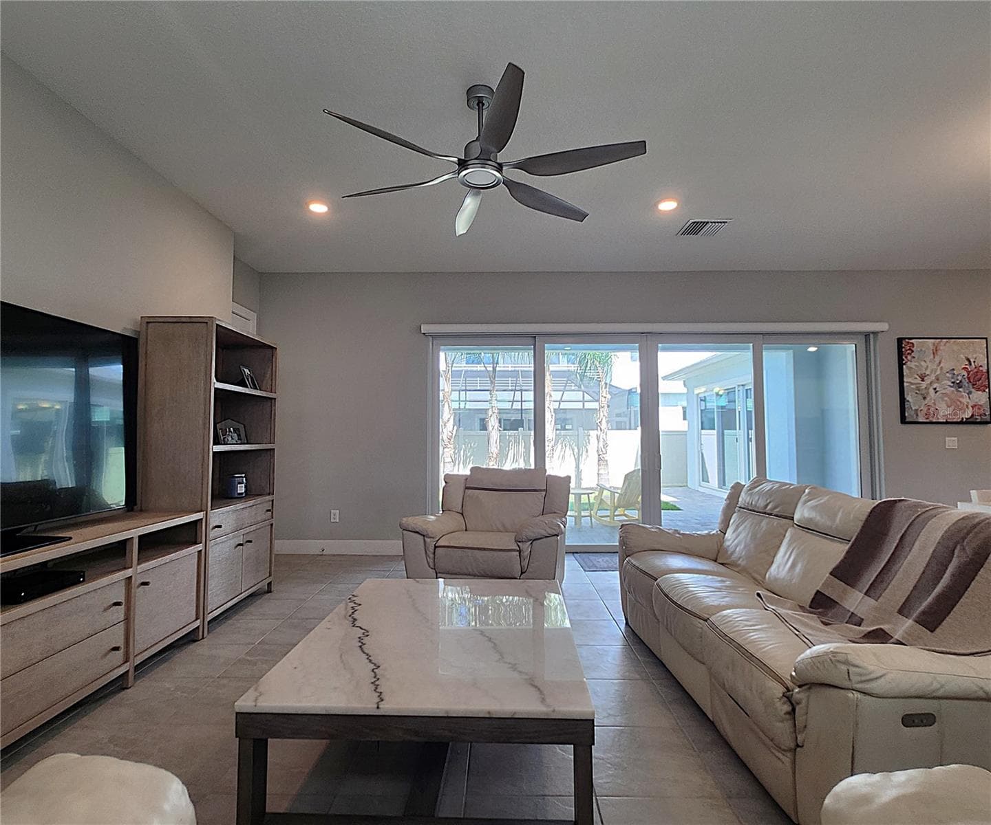 Main home: plantation shutters, remote controlled shade, large living room, dining area, large open kitchen, 3 bedrooms, 2 full bathrooms, 1 guest bathroom, interior laundry room - 8896 DRUMMER PLANK DR, WESLEY CHAPEL