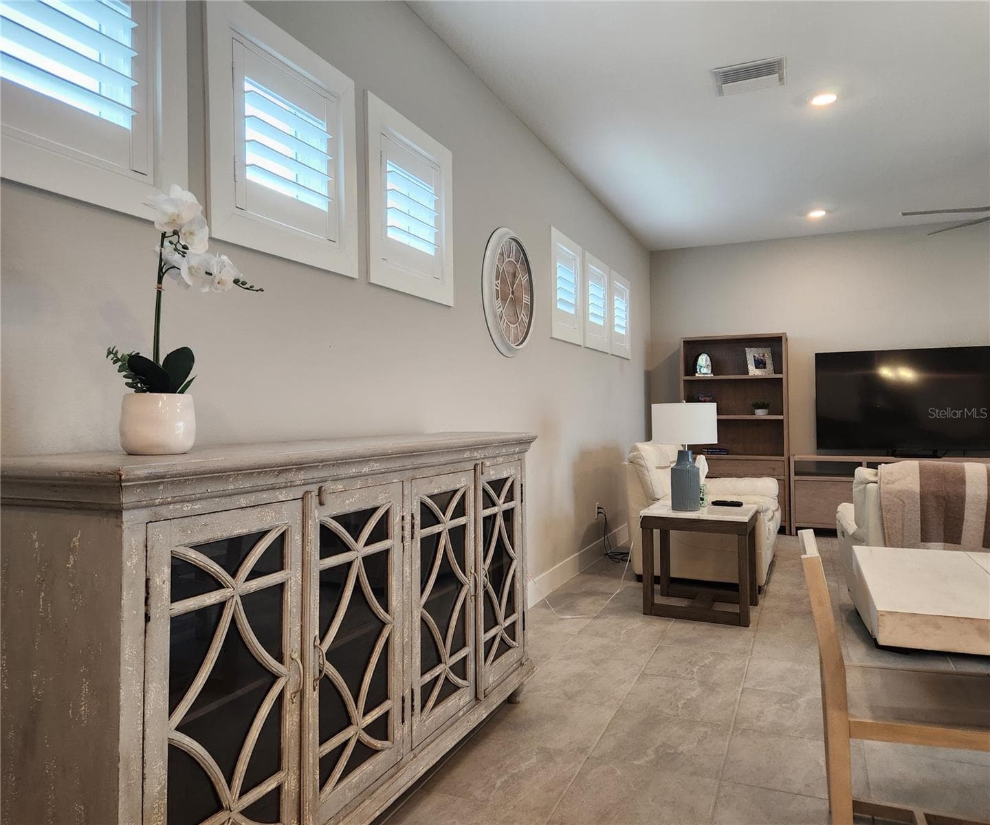 Main home: plantation shutters, remote controlled shade, large living room, dining area, large open kitchen, 3 bedrooms, 2 full bathrooms, 1 guest bathroom, interior laundry room - 8896 DRUMMER PLANK DR, WESLEY CHAPEL