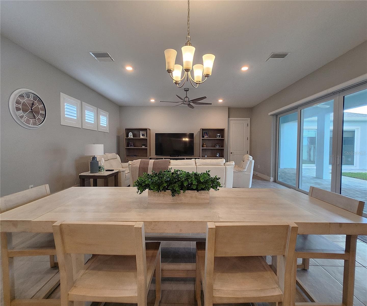 Main home: plantation shutters, remote controlled shade, large living room, dining area, large open kitchen, 3 bedrooms, 2 full bathrooms, 1 guest bathroom, interior laundry room - 8896 DRUMMER PLANK DR, WESLEY CHAPEL