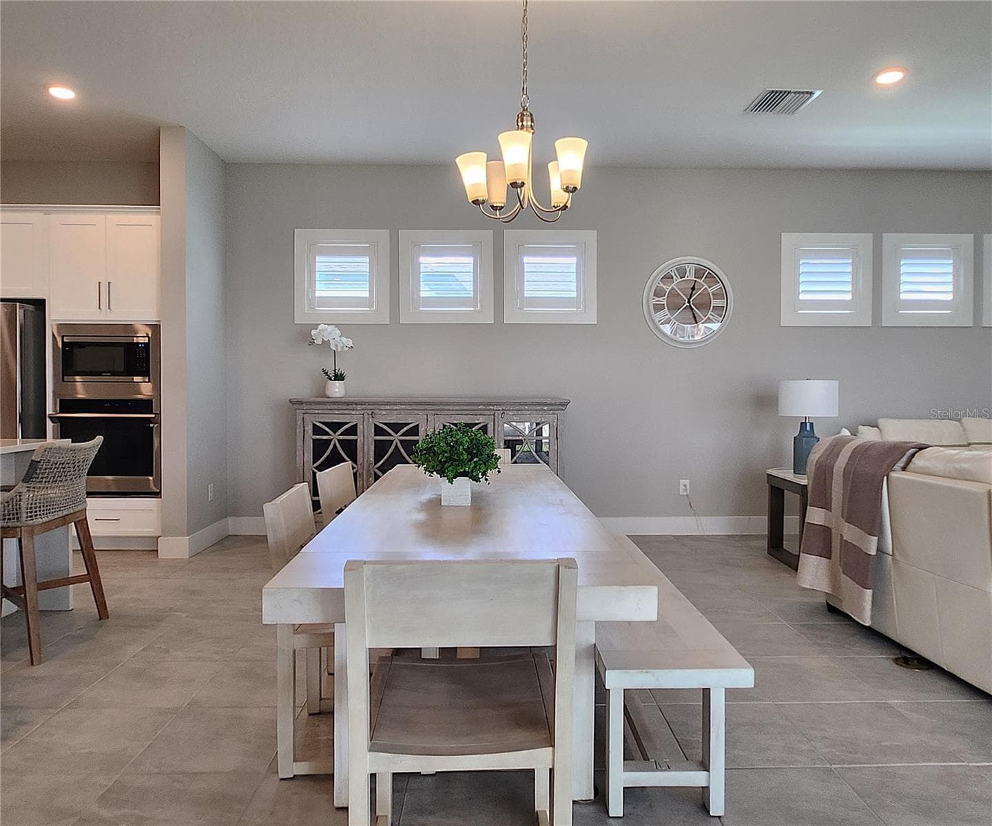 Main home: plantation shutters, remote controlled shade, large living room, dining area, large open kitchen, 3 bedrooms, 2 full bathrooms, 1 guest bathroom, interior laundry room - 8896 DRUMMER PLANK DR, WESLEY CHAPEL