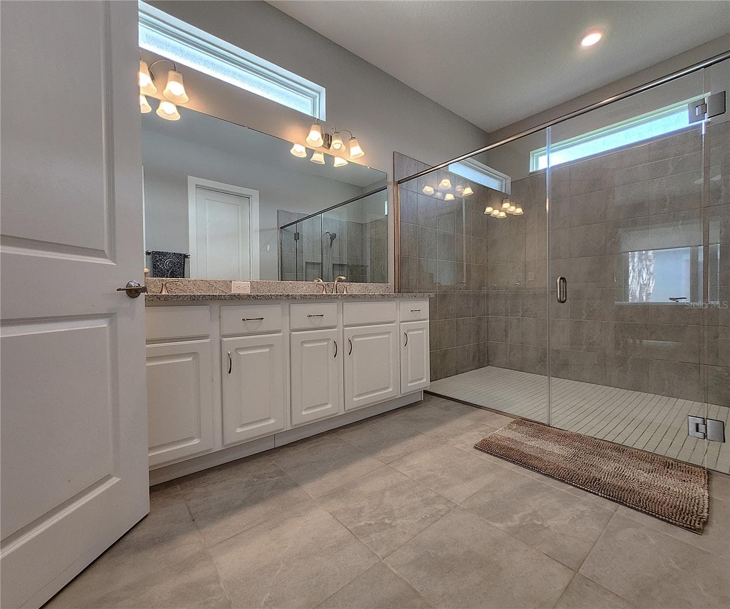 Master bathroom includes large walk-in tiled shower, water closet, walk-in closet, dual sink vanity, granite countertops - 8896 DRUMMER PLANK DR, WESLEY CHAPEL