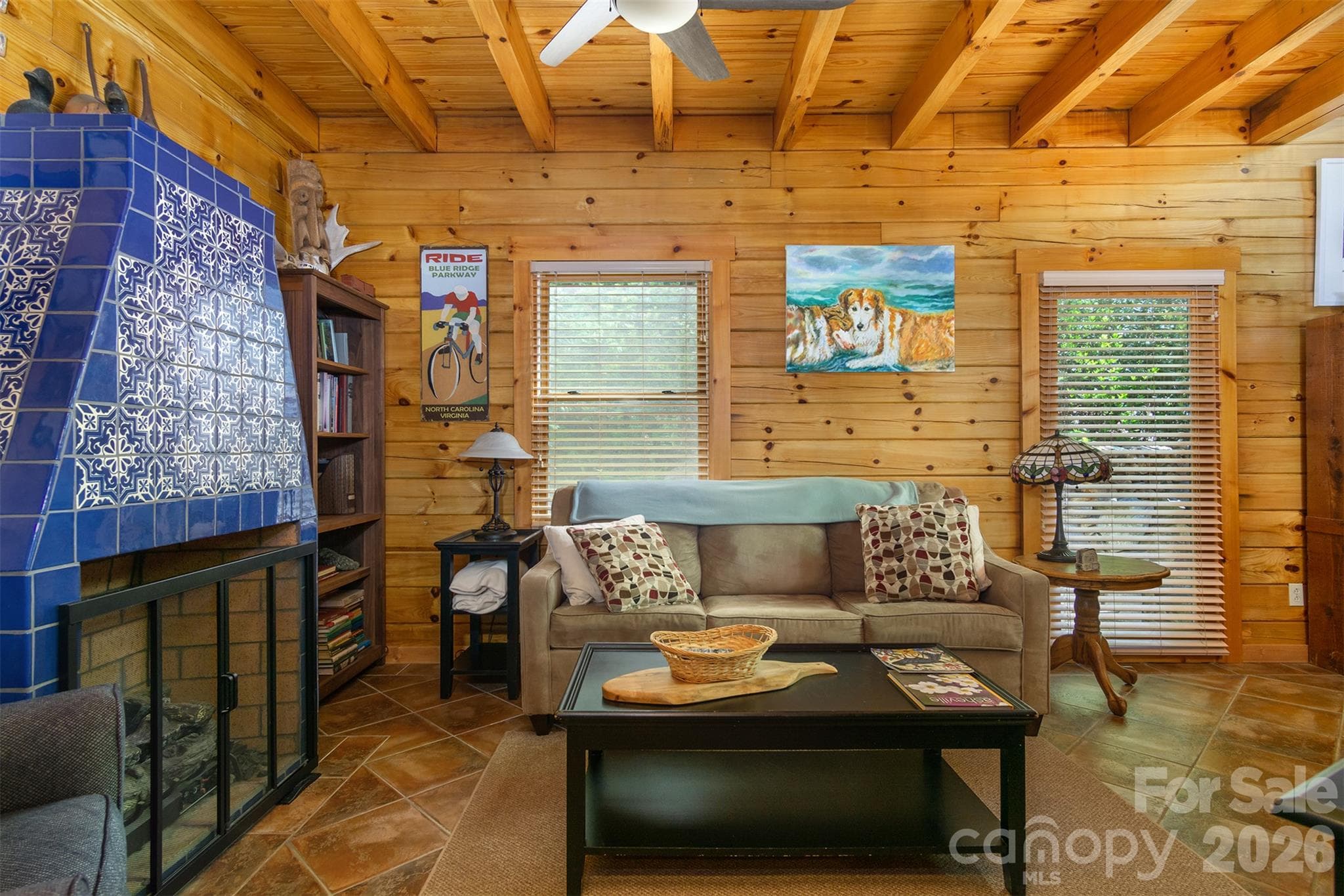 Living area has a gas log fire place Mexican tiles and custom tile work. - 171 Camp Elliott Road, Black Mountain