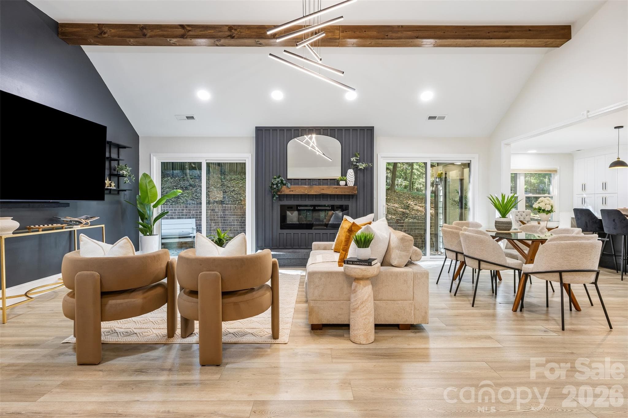A cozy fireplace and statement accent wall anchor the living room - 16 Tanglewood Road, Lake Wylie