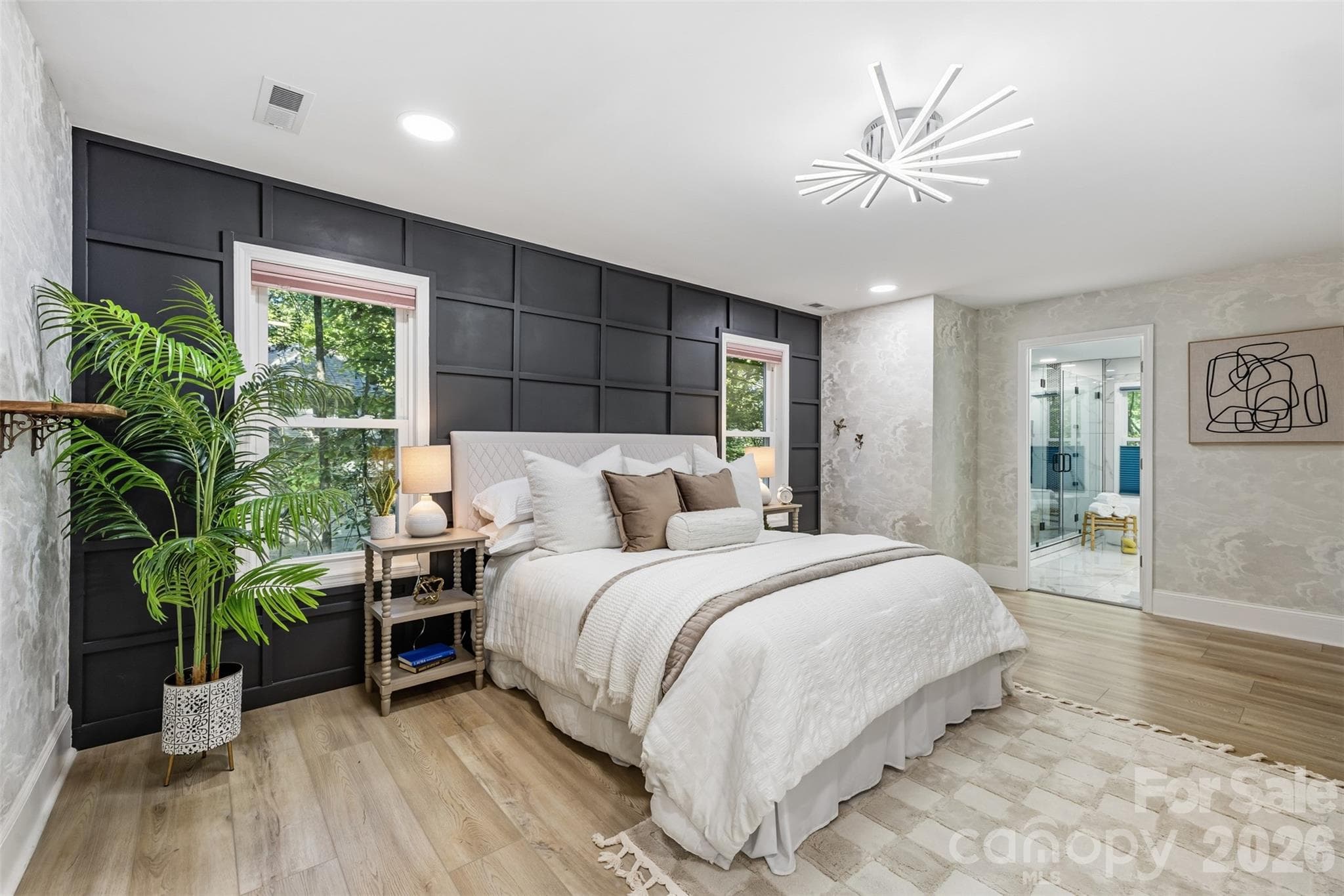 Large primary suite features LVP & wood paneled accent wall - 16 Tanglewood Road, Lake Wylie