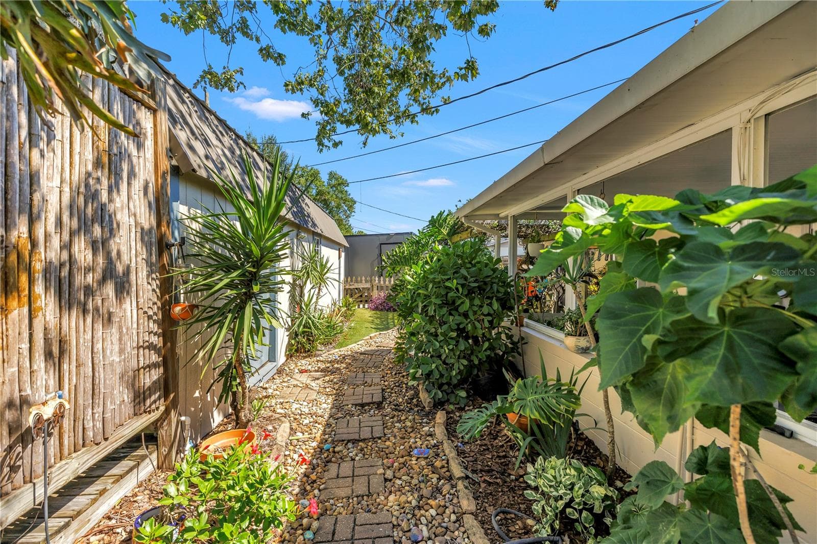 Garden path leading to workshop, gazebo and oversized secondary gated parking. - 2573 62ND TER N, ST PETERSBURG