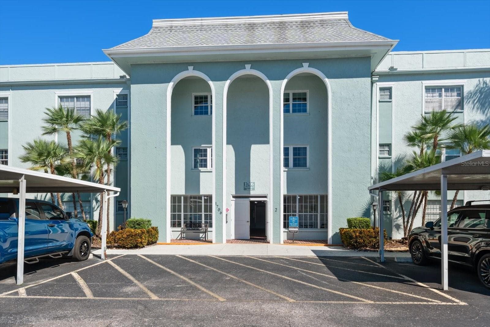 Front of condo building and carports - 1706 BELLEAIR FOREST DR #238, BELLEAIR