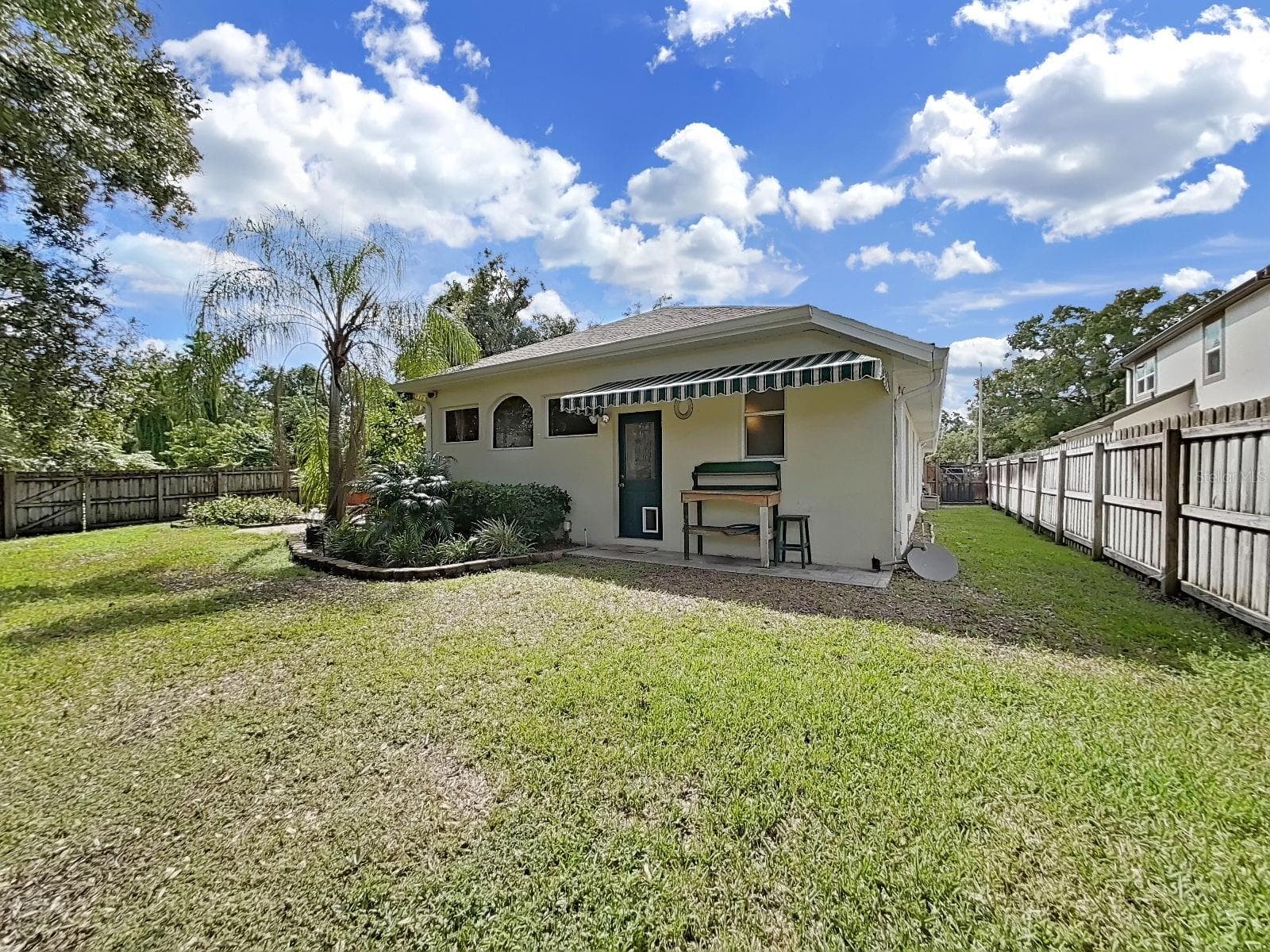Back Garden ~ Canopy over Additional Back Entrance ~ Completely Fenced - 14915 DEVONSHIRE WOODS PL, TAMPA